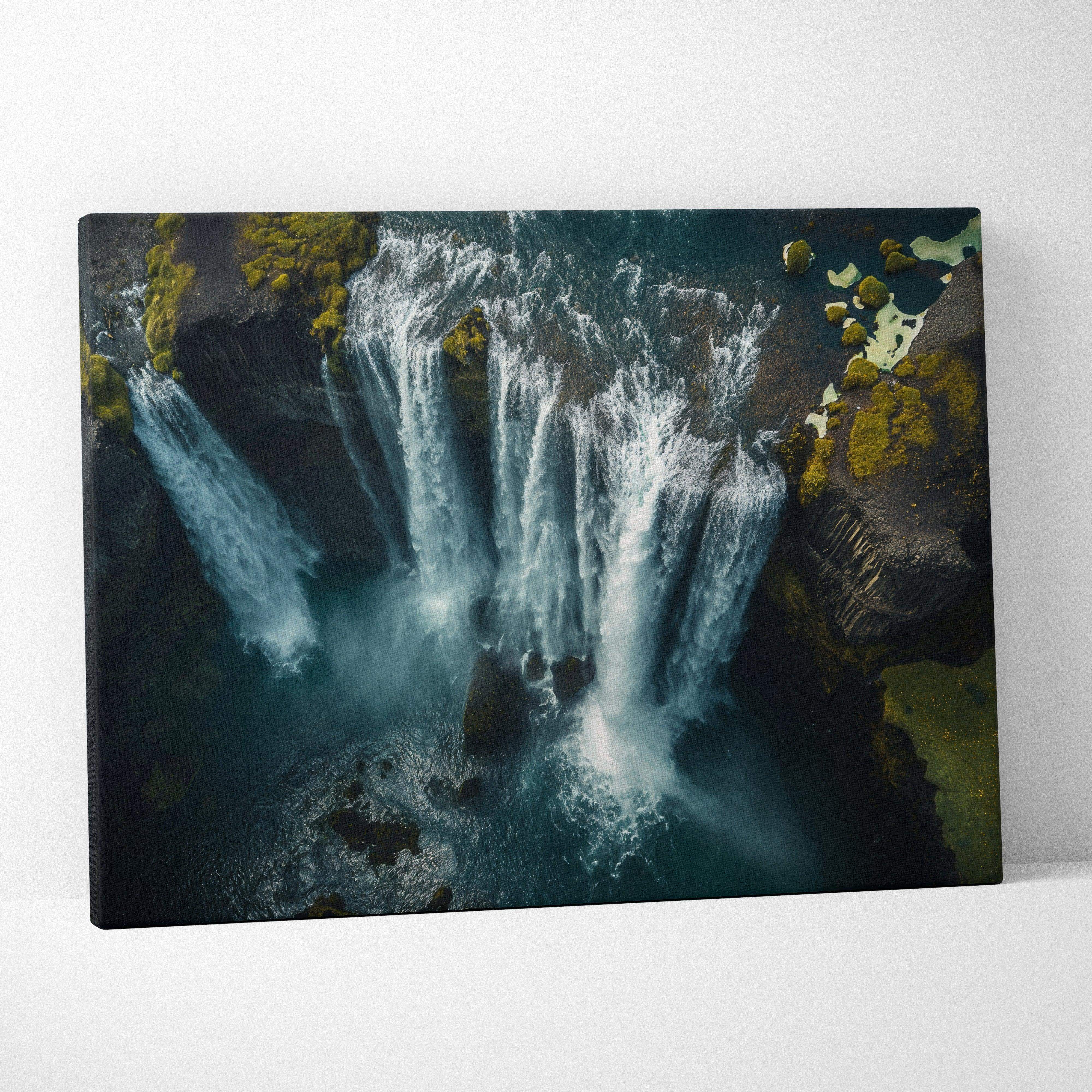 A canvas print of an aerial landscape iceland waterfall with mossy rocks in moody blues and teal tones with mist
