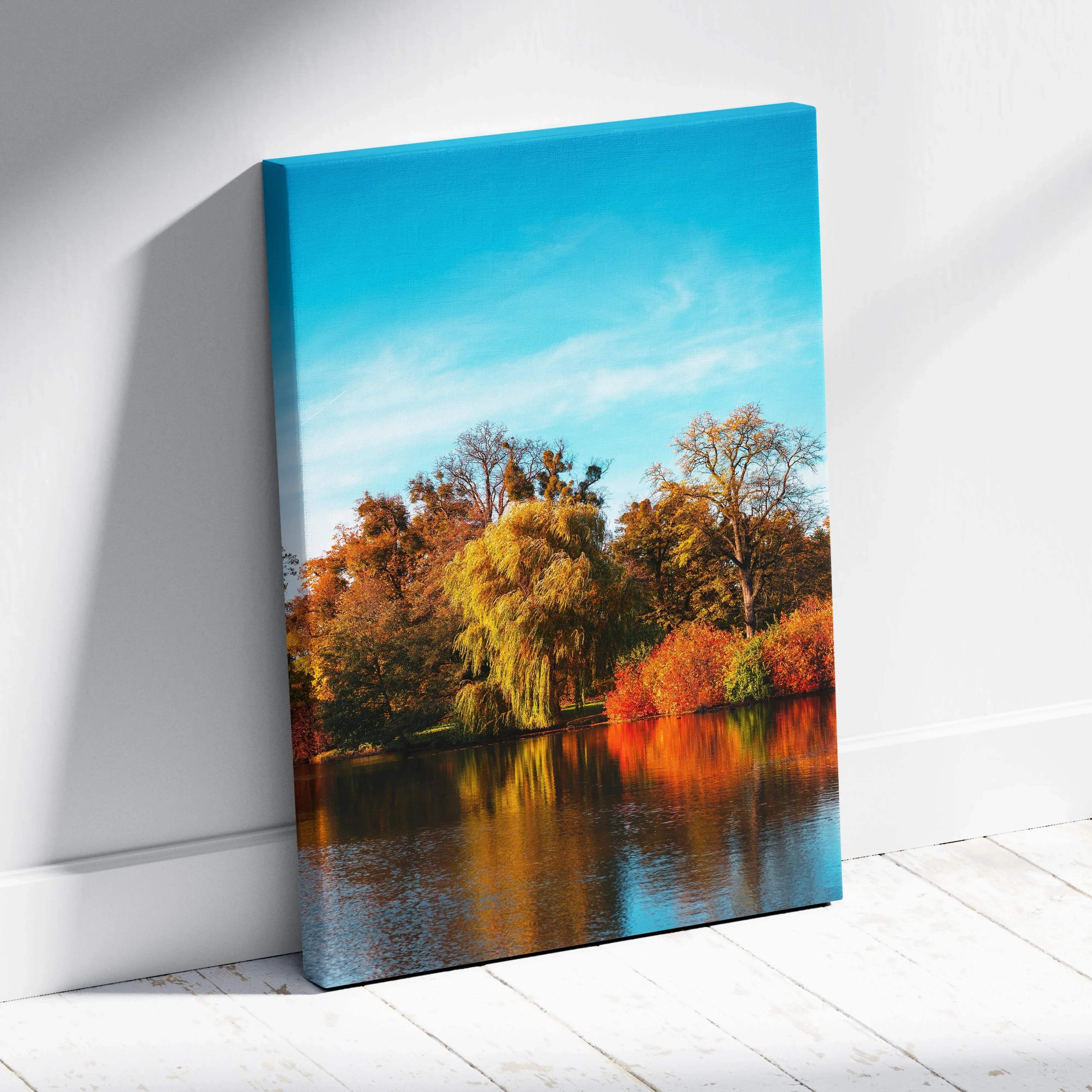 Warm autumn landscape canvas wall art featuring golden foliage and trees by a lake under a clear blue sky