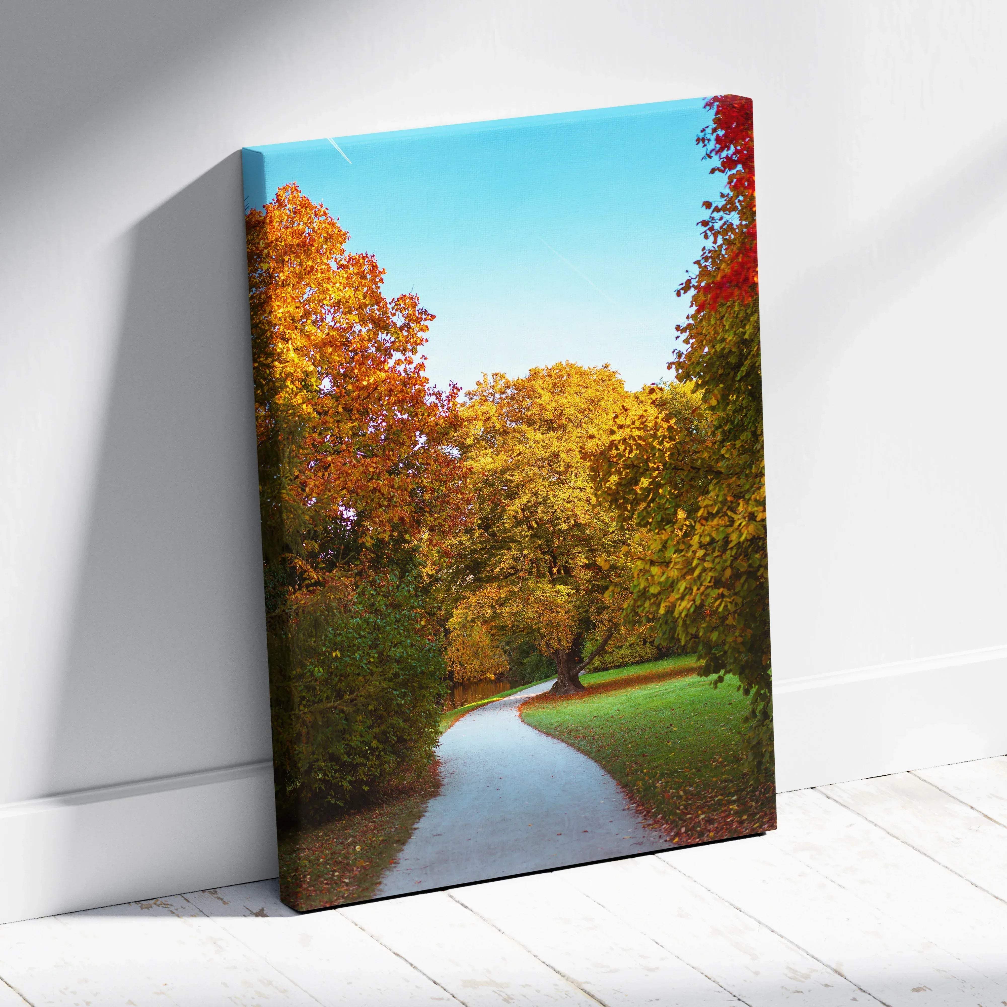 Autumn landscape canvas wall art featuring a sunlit winding path through vibrant orange yellow and red trees