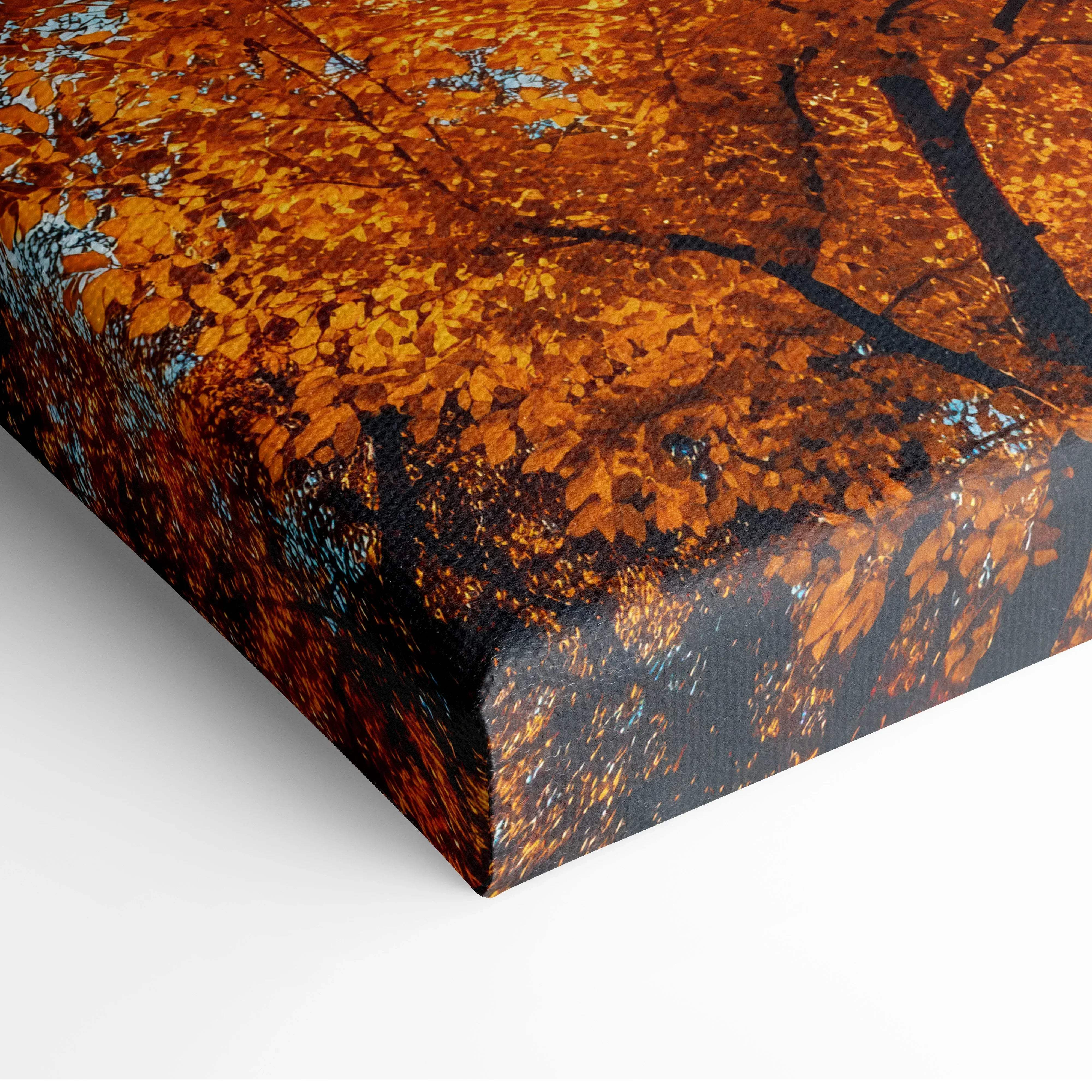 Autumn forest canopy canvas wall art featuring vibrant golden orange fall foliage on dark branches against blue sky