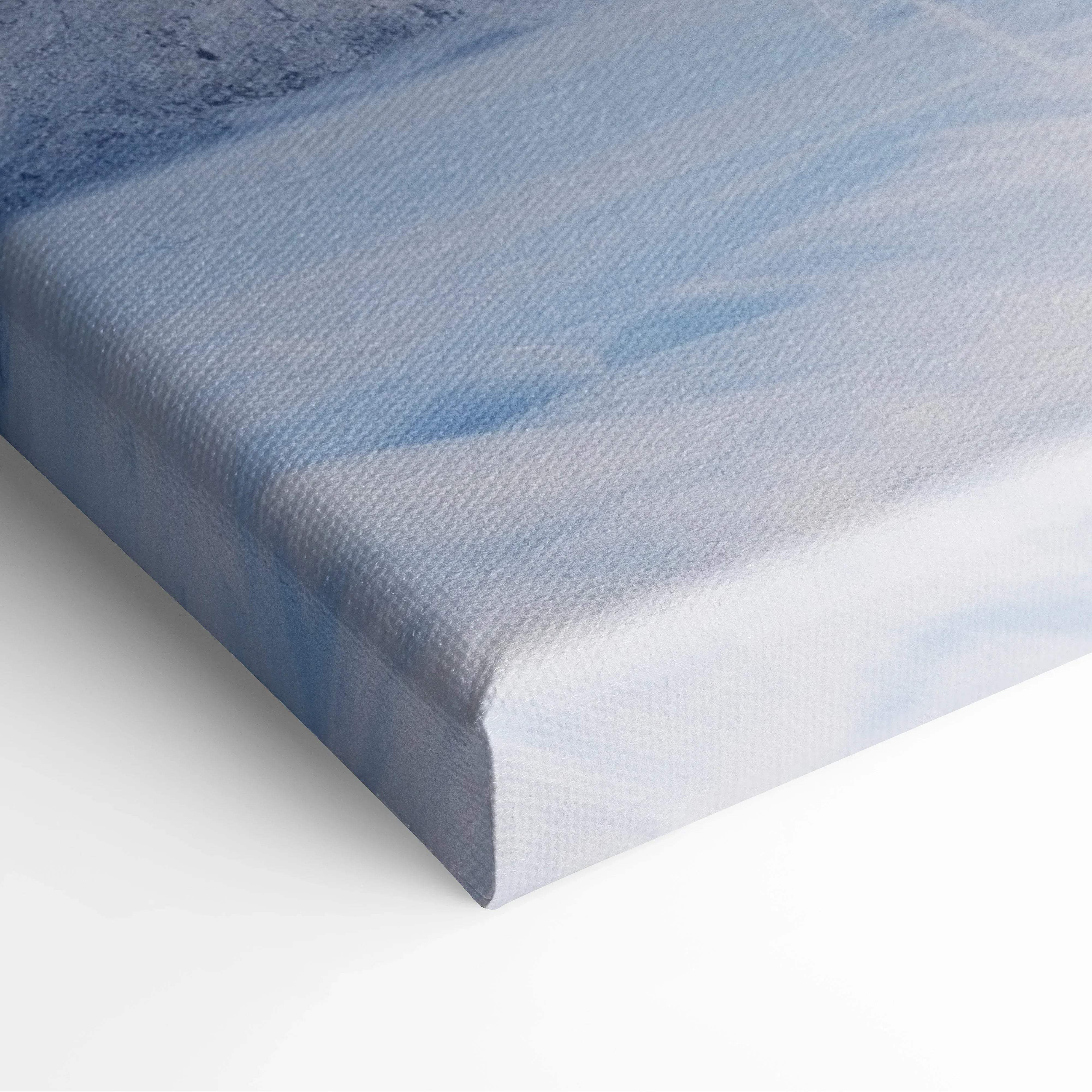 Blue and white abstract canvas wall art with textured watercolor brushstrokes depicting a winter landscape scene