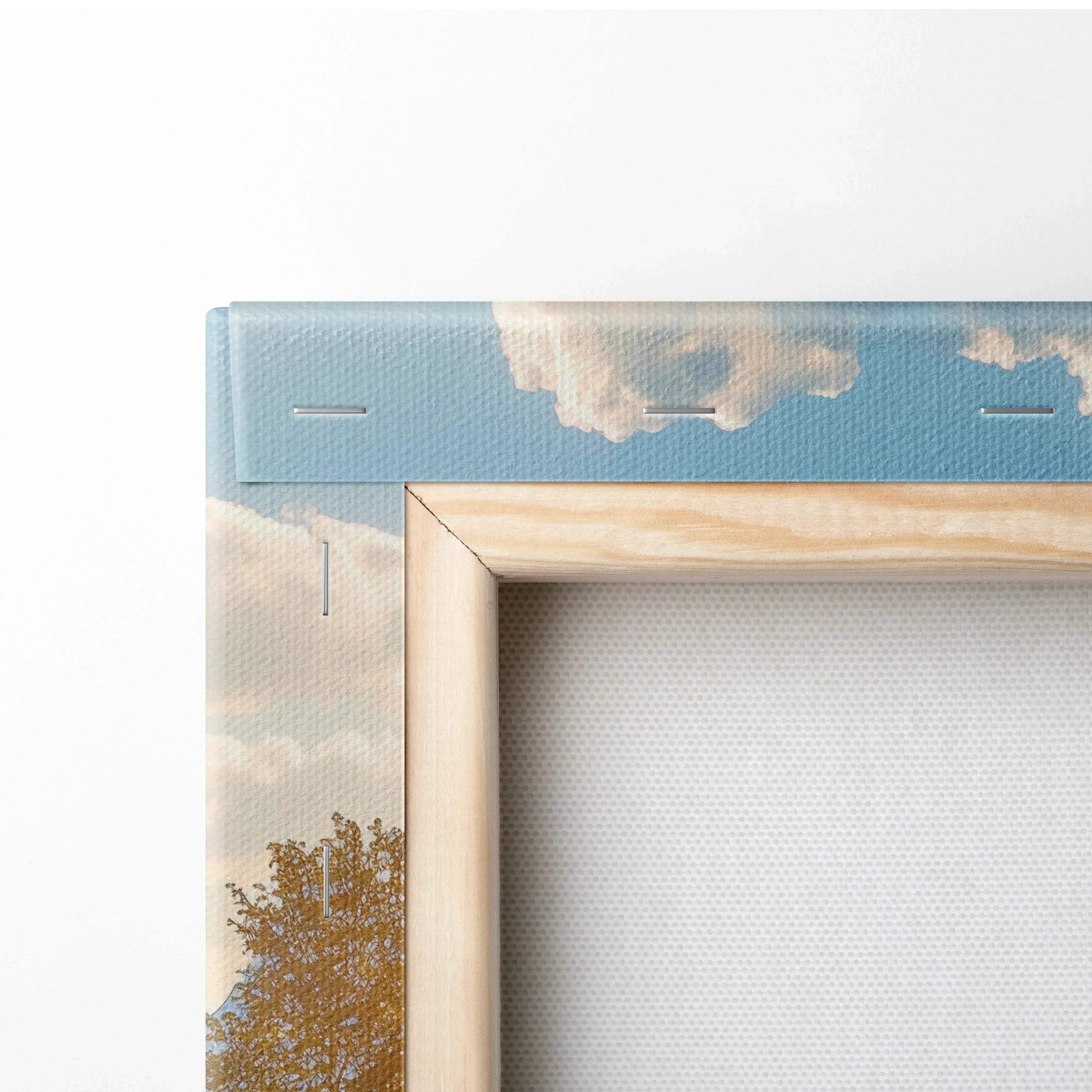 Light wood frame with canvas print of serene sky, clouds, golden treetops