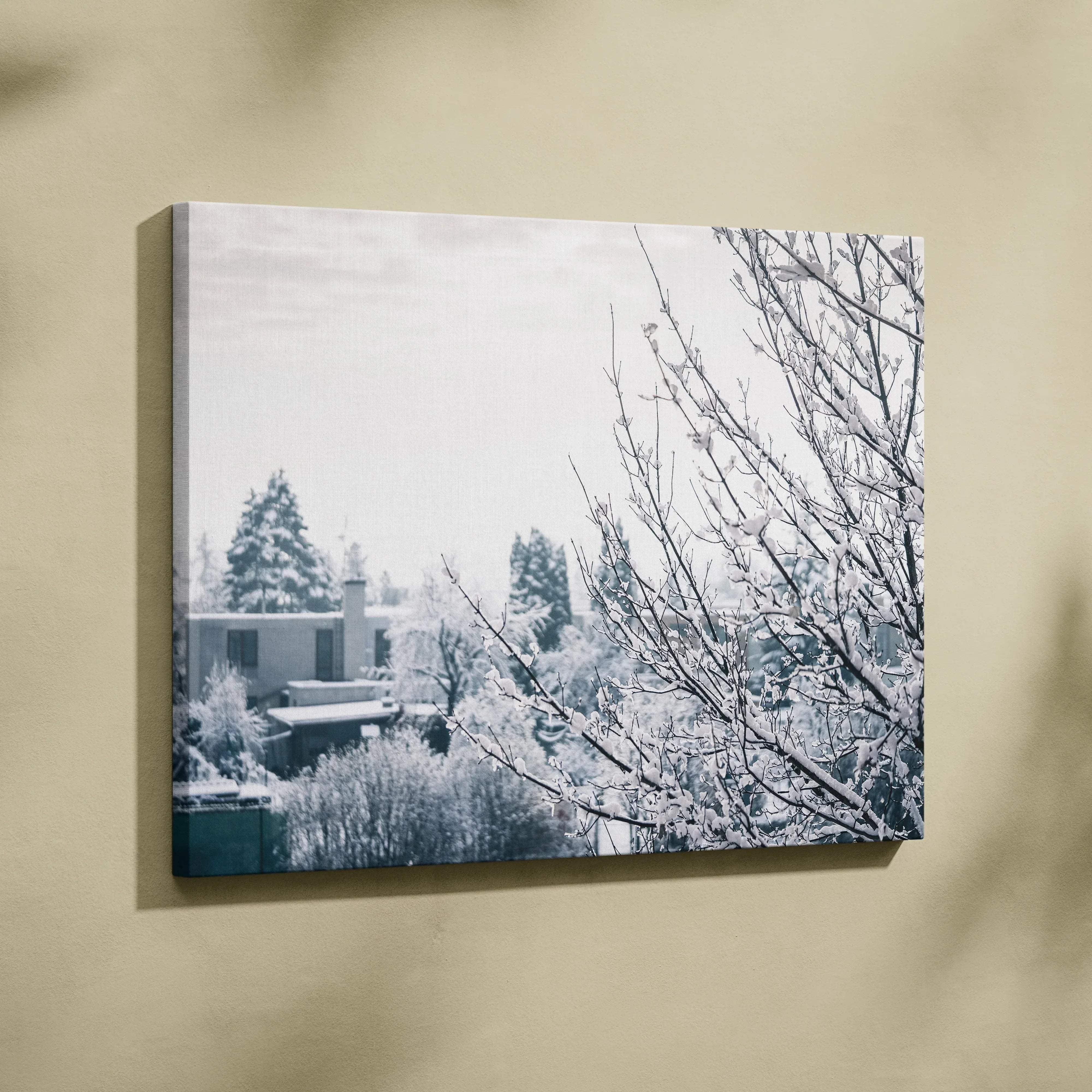 Black-and-white canvas wall art depicting snowy trees and houses in soft blue gray tones for serene living room decor