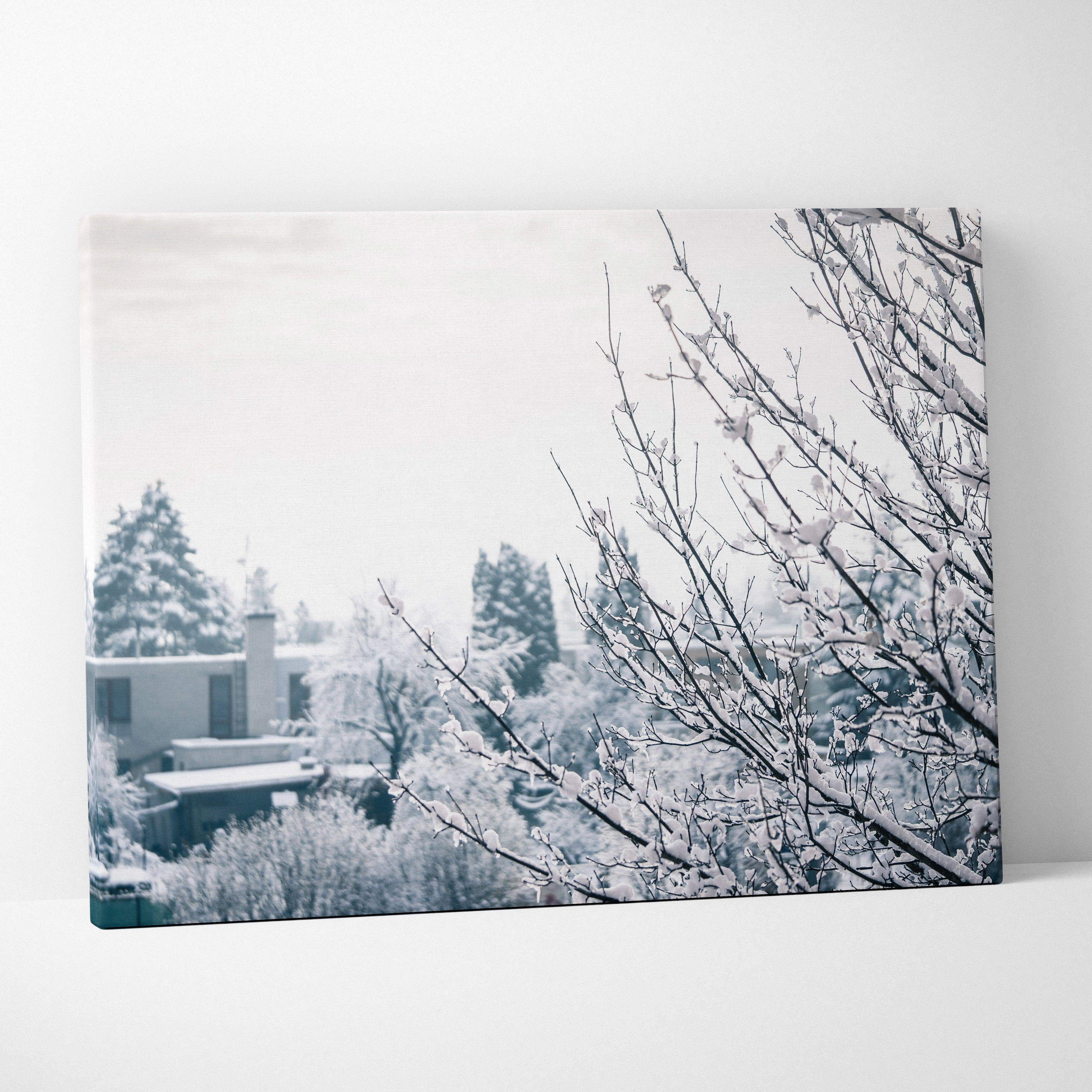 Winter landscape canvas wall art with snow-dusted branches in soft blue gray tones for serene living room decor
