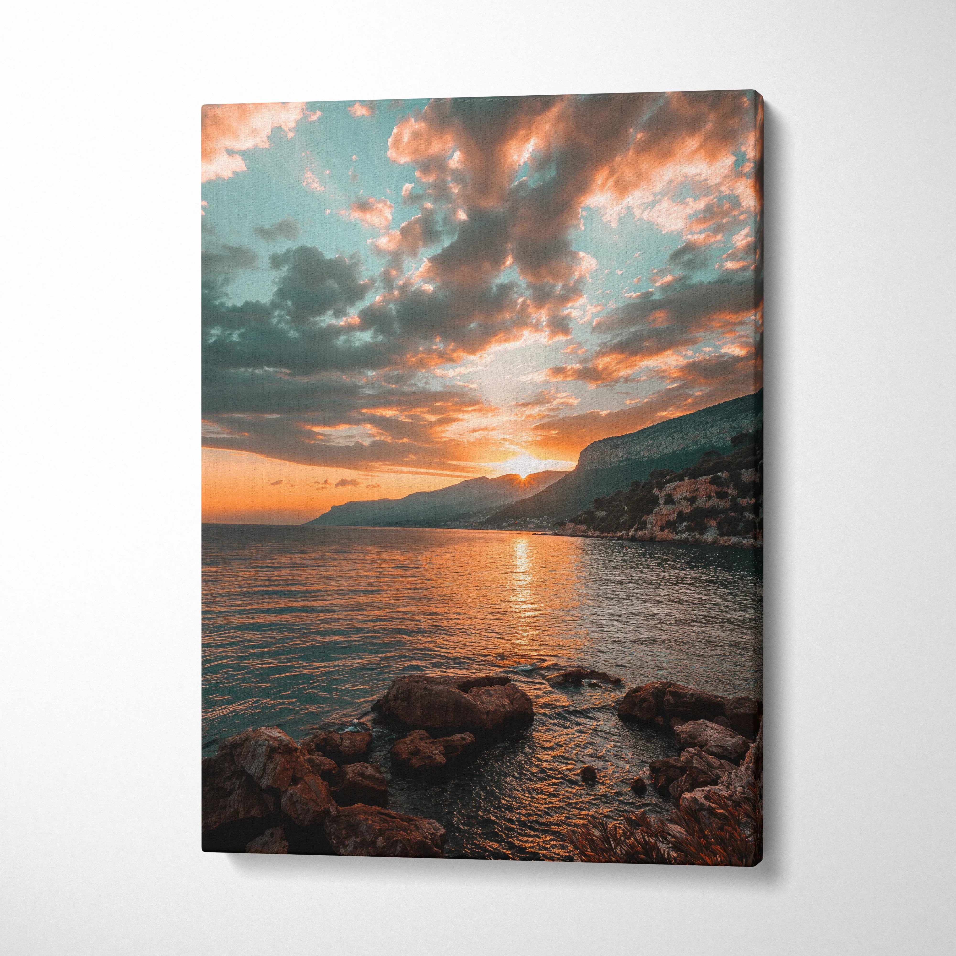 Sunset beach scene with rocky shoreline and dramatic clouds on rectangular canvas wall art.