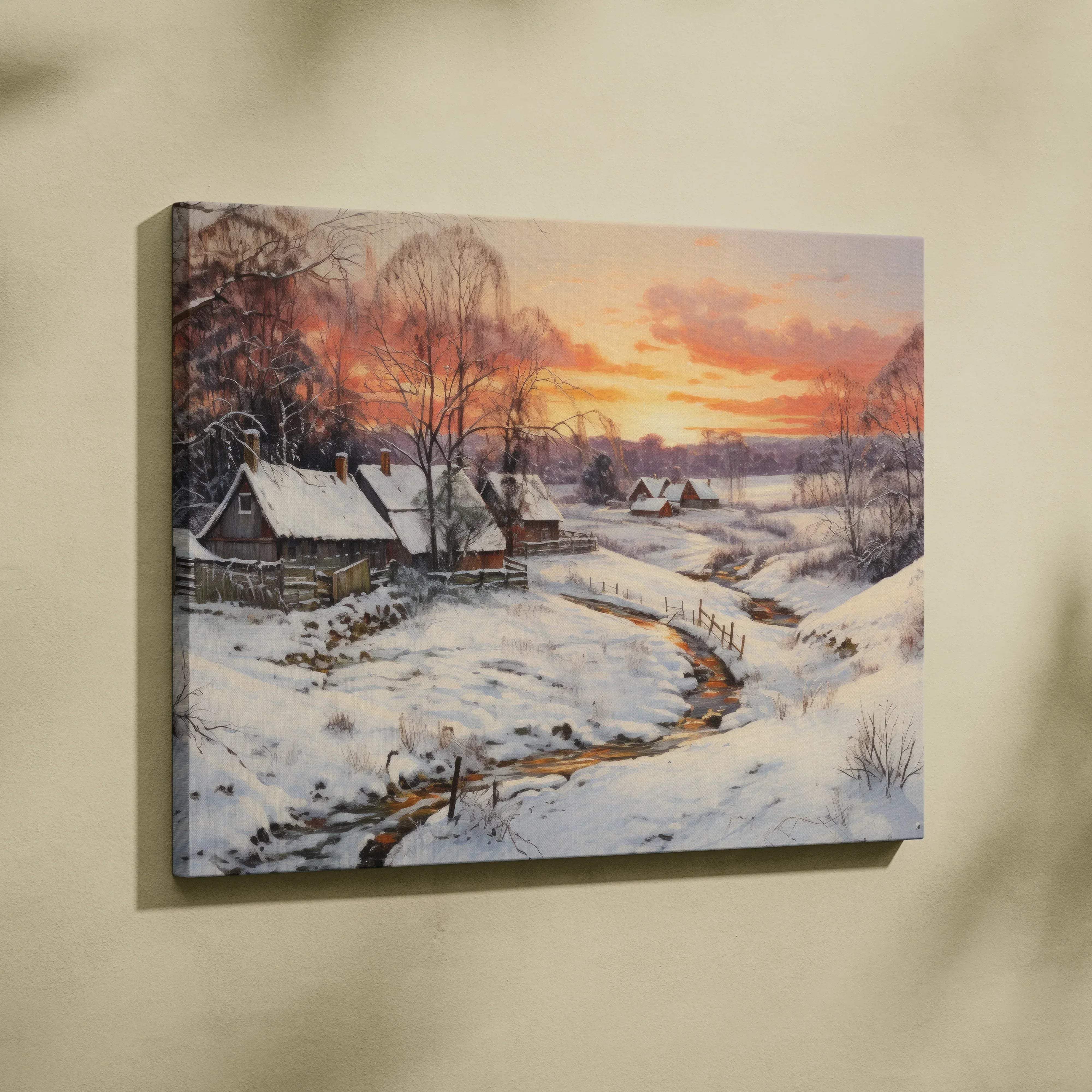 Winter landscape canvas wall art featuring a snowy village by creek at sunset with warm orange pink hues