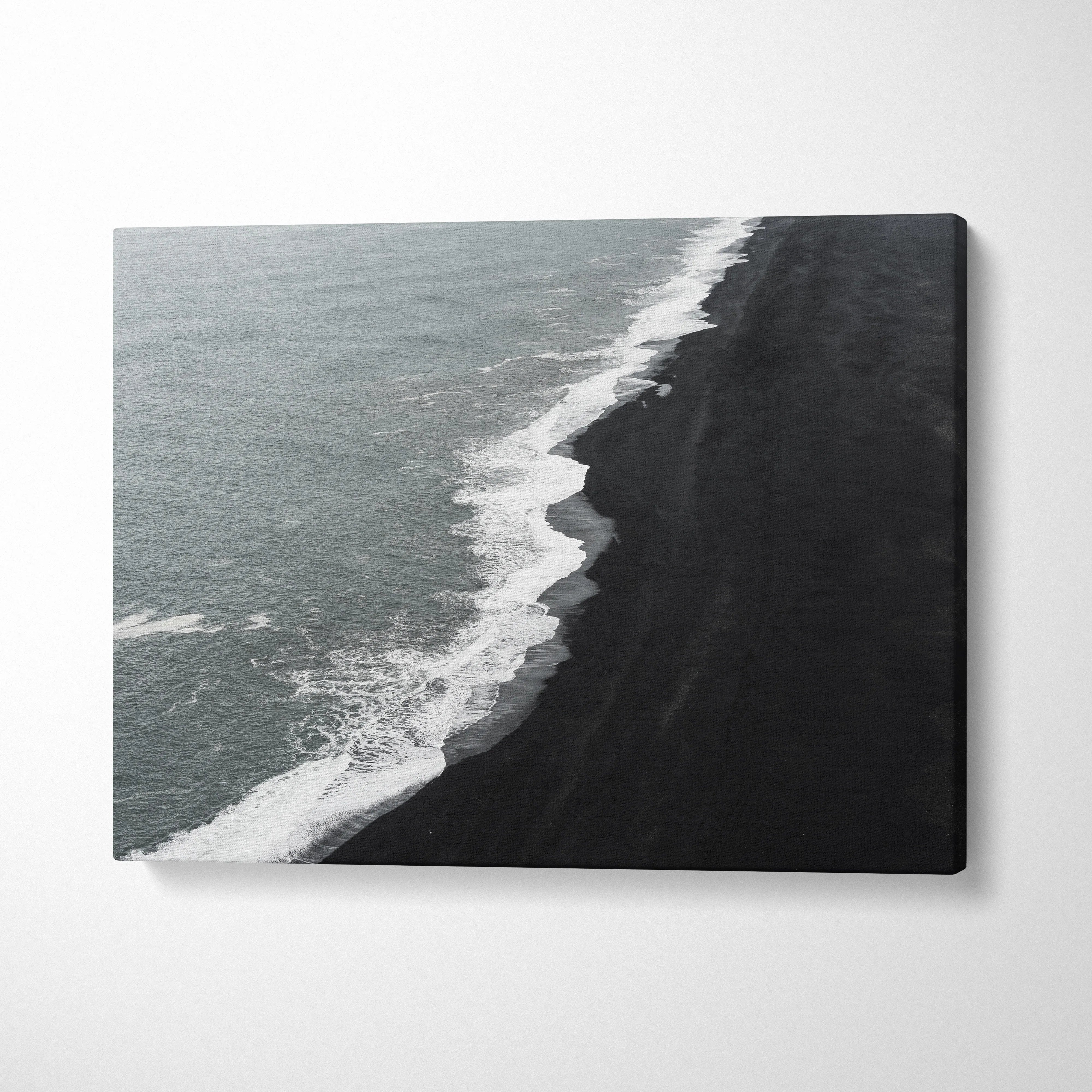 Monochrome canvas print of Icelandic black sand beach with dramatic waves