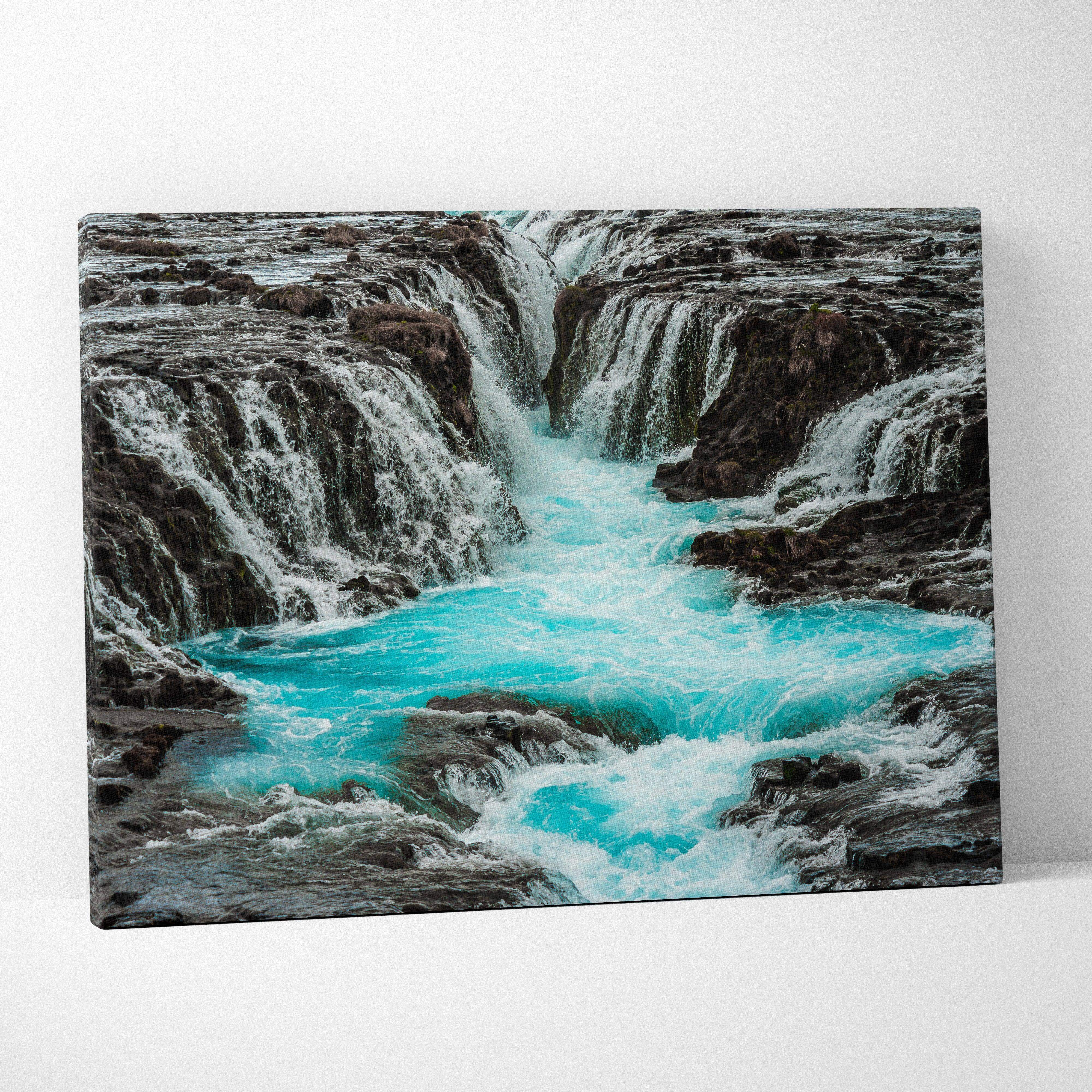 Icelandic waterfall scene canvas wall art with vibrant turquoise waterfall over dark rugged rocks for serene nature decor