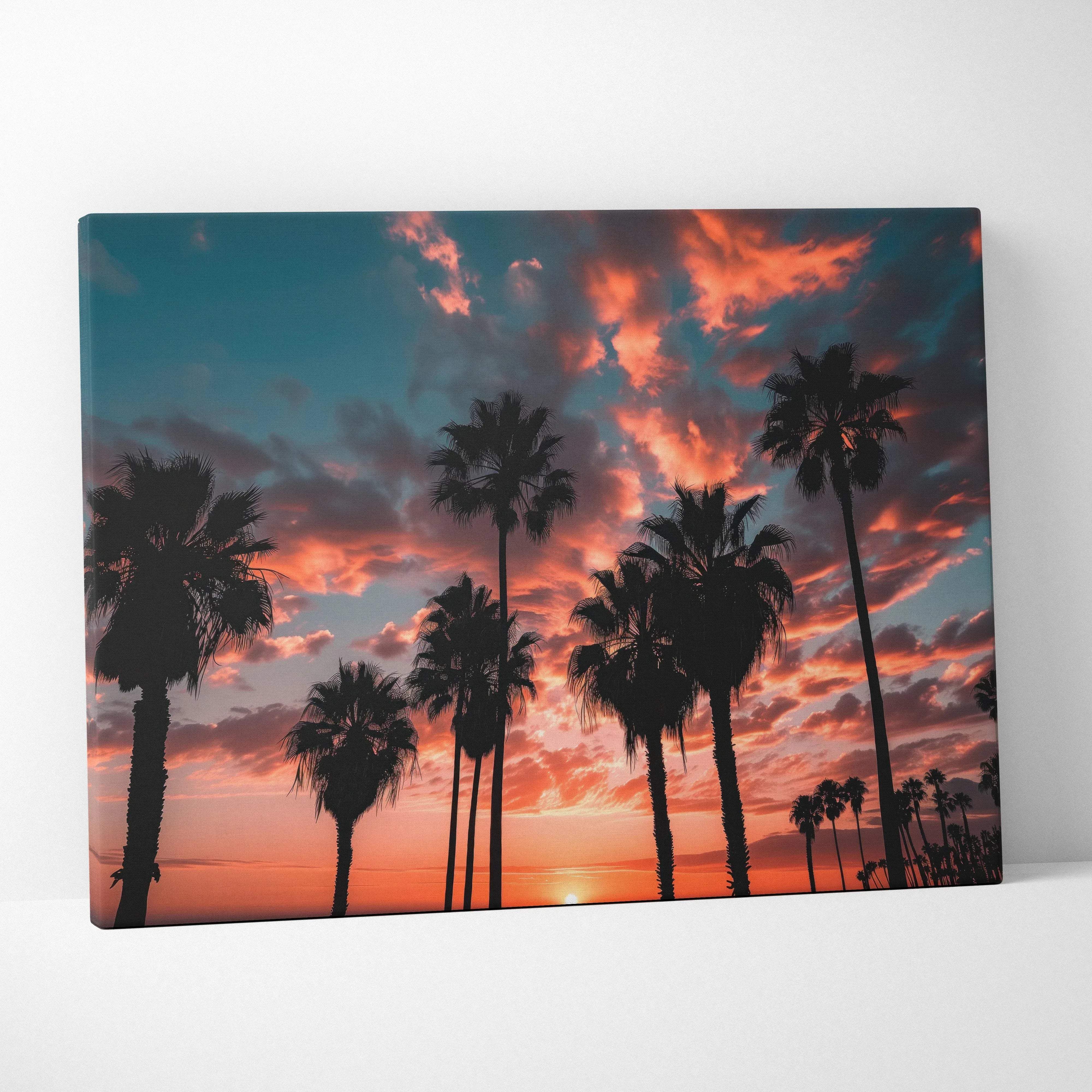 Canvas print of silhouetted palm trees at California coast sunset