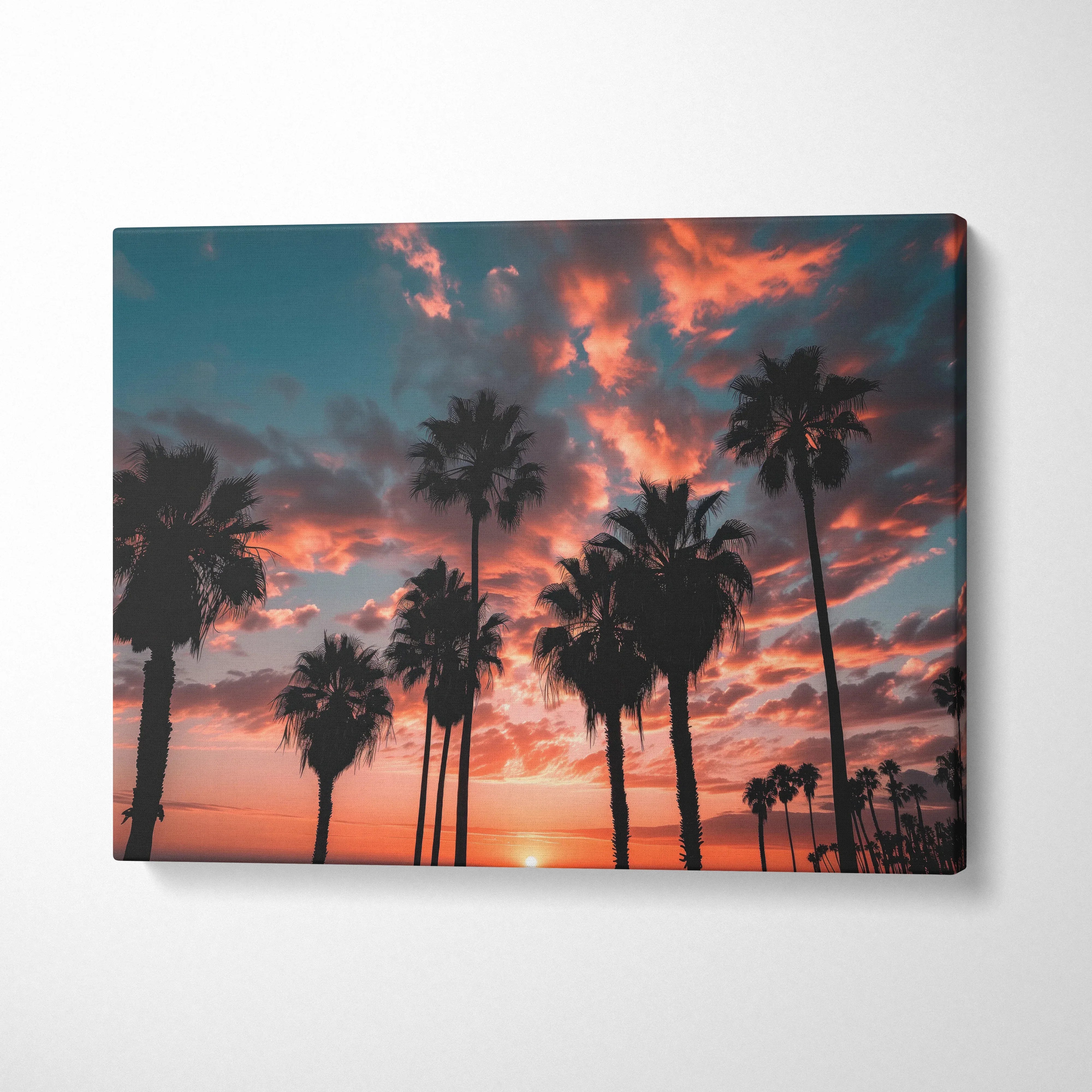 Canvas print of silhouetted palm trees at California coast sunset