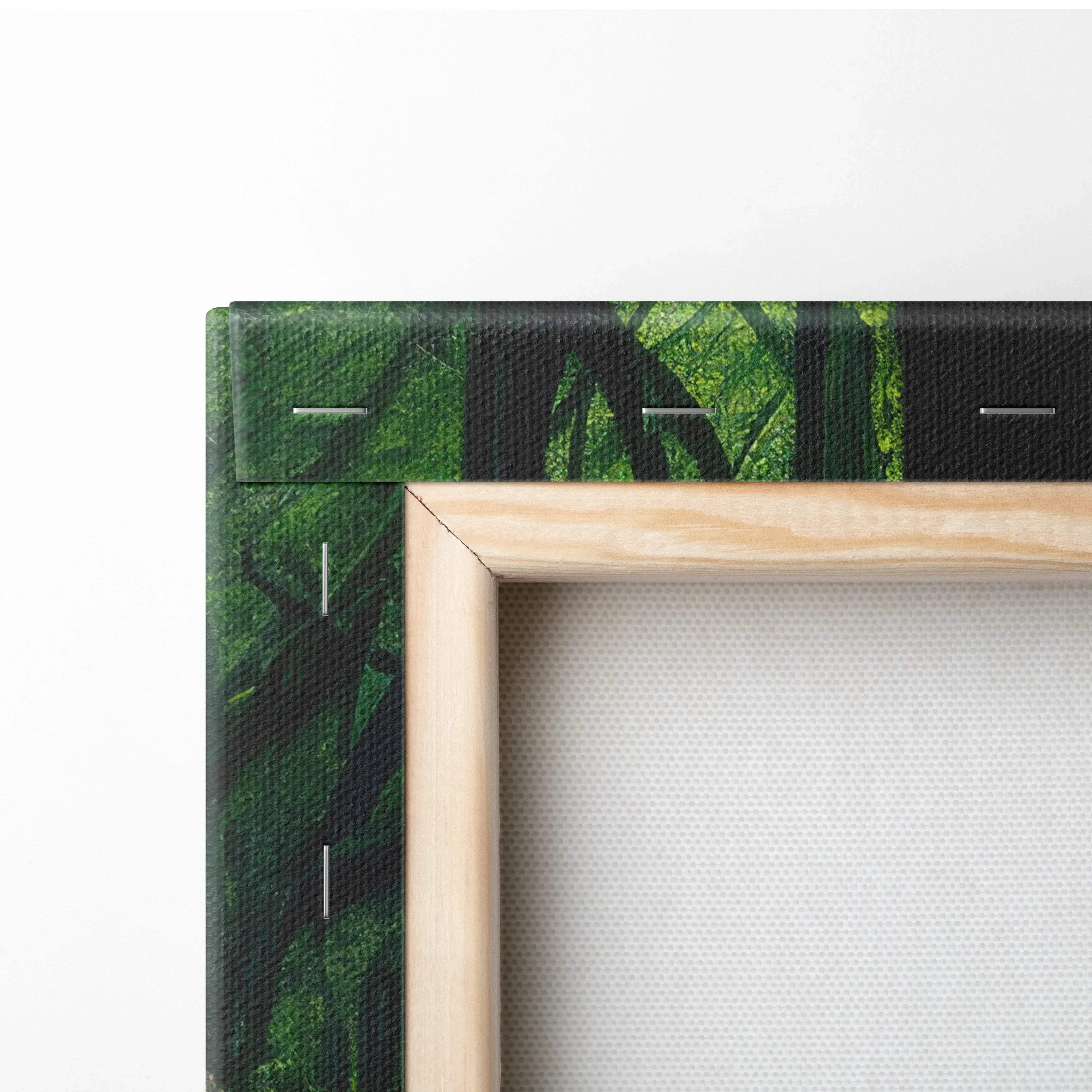 Light wood-framed canvas wall art featuring a vibrant green forest with dark foliage and textured fabric backing
