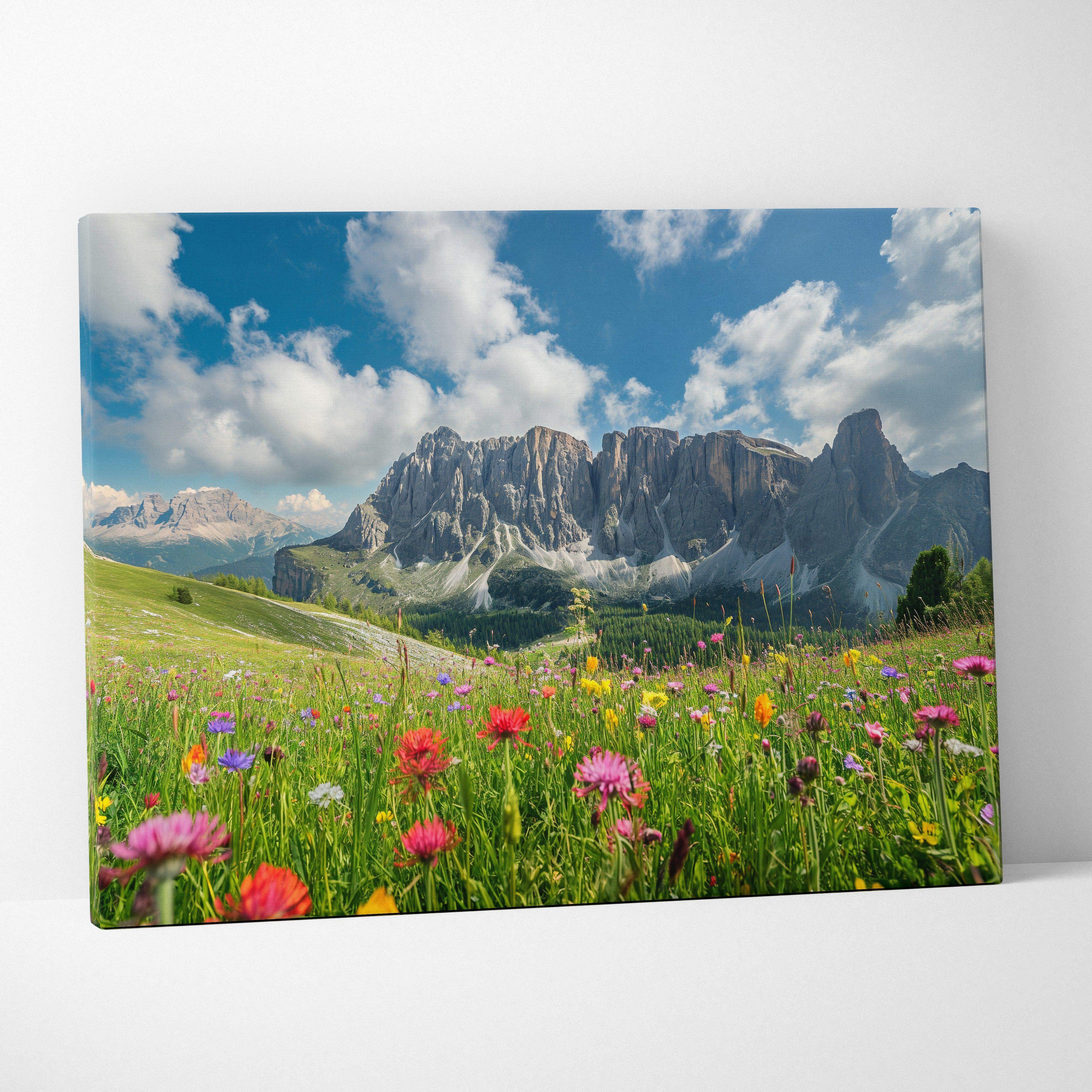 Vibrant canvas wall art of a floral mountain landscape with colorful wildflowers in a meadow under clear blue sky