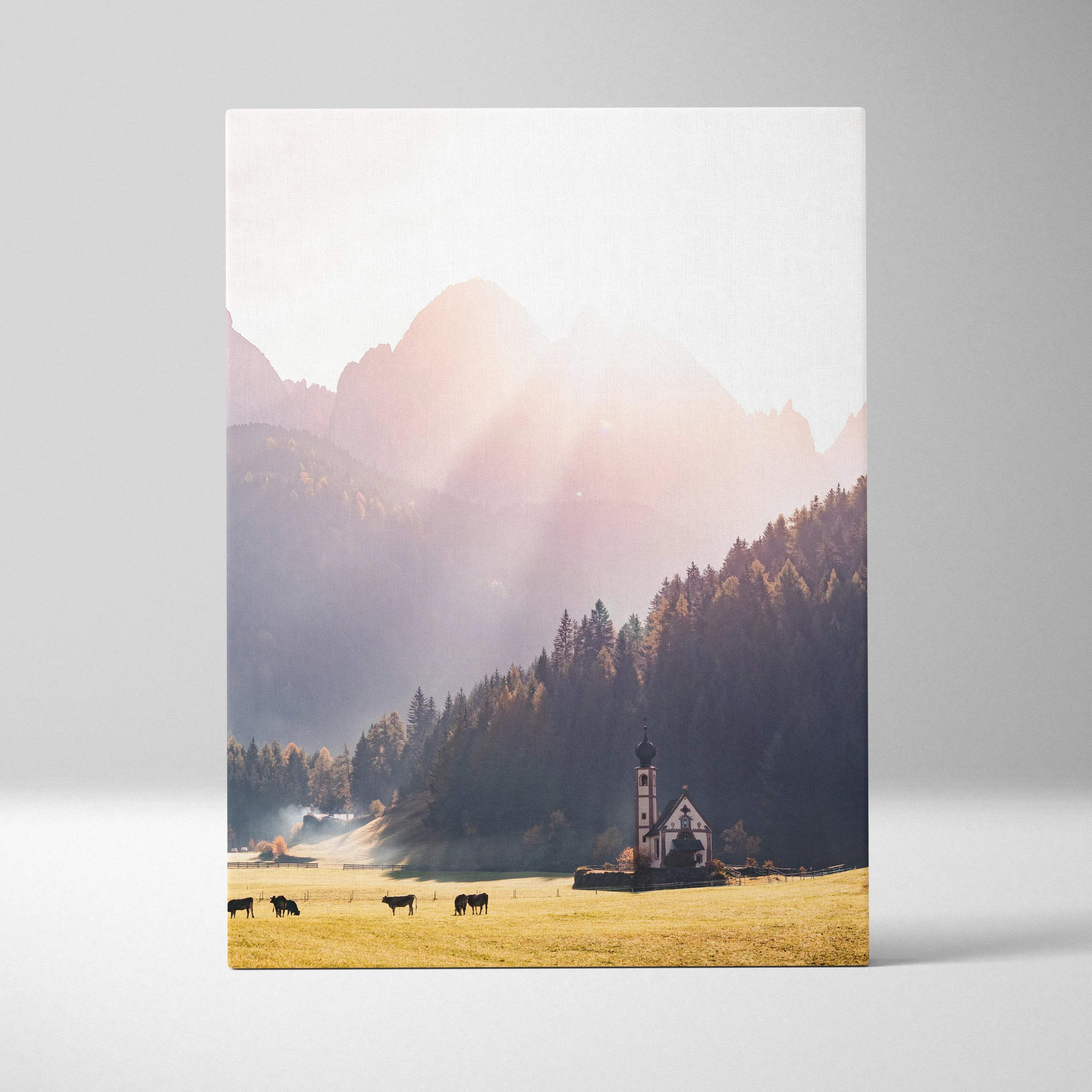 Rectangular canvas wall art depicting a pastel sunrise autumn mountain valley with a white chapel and golden field