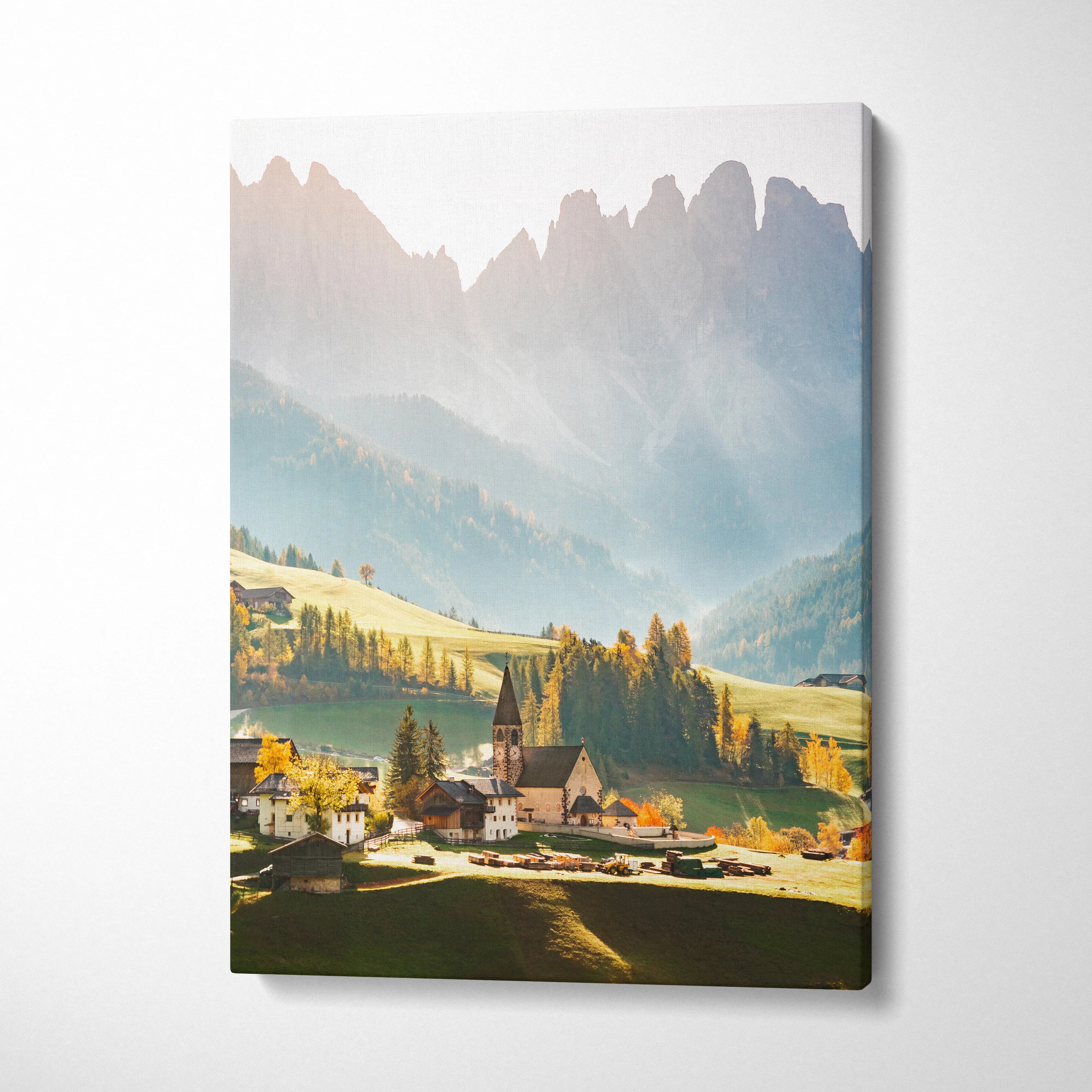 Vertical canvas wall art featuring a serene mountain village with soft morning light and misty peaks.