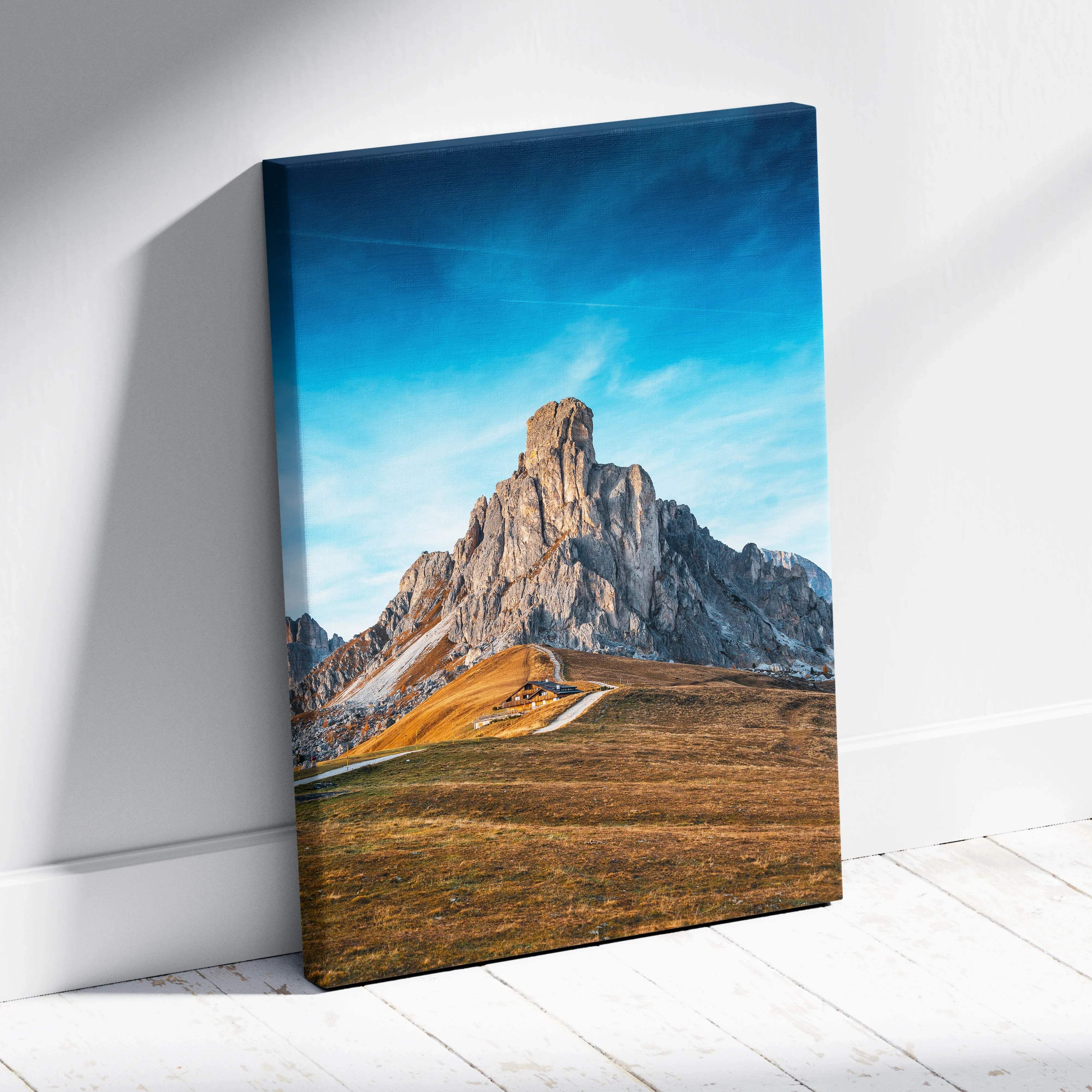 Canvas print of Ra Gusela Peak over Giau Pass, serene blue sky