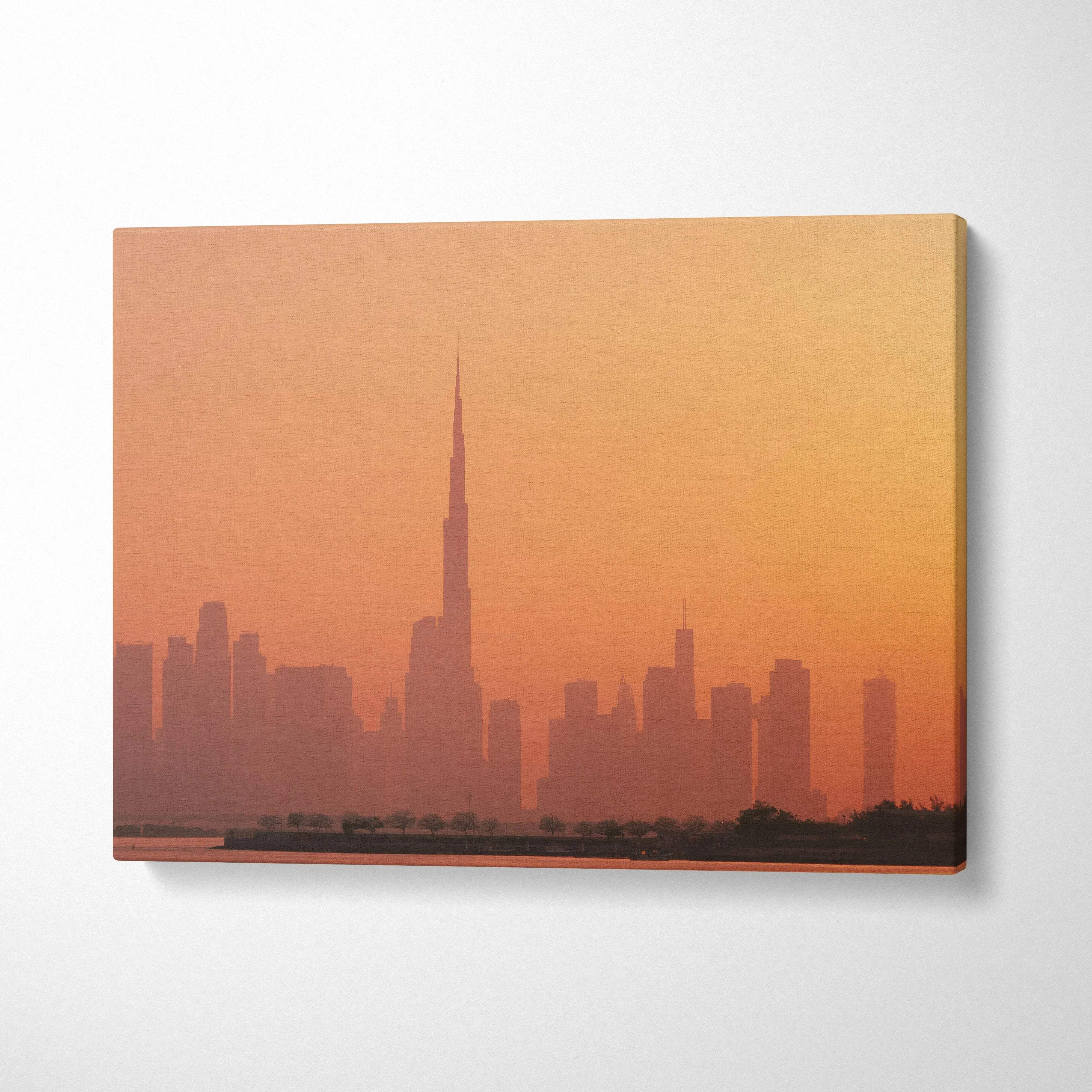 Sunset city skyline canvas wall art with tall buildings in warm orange tones.