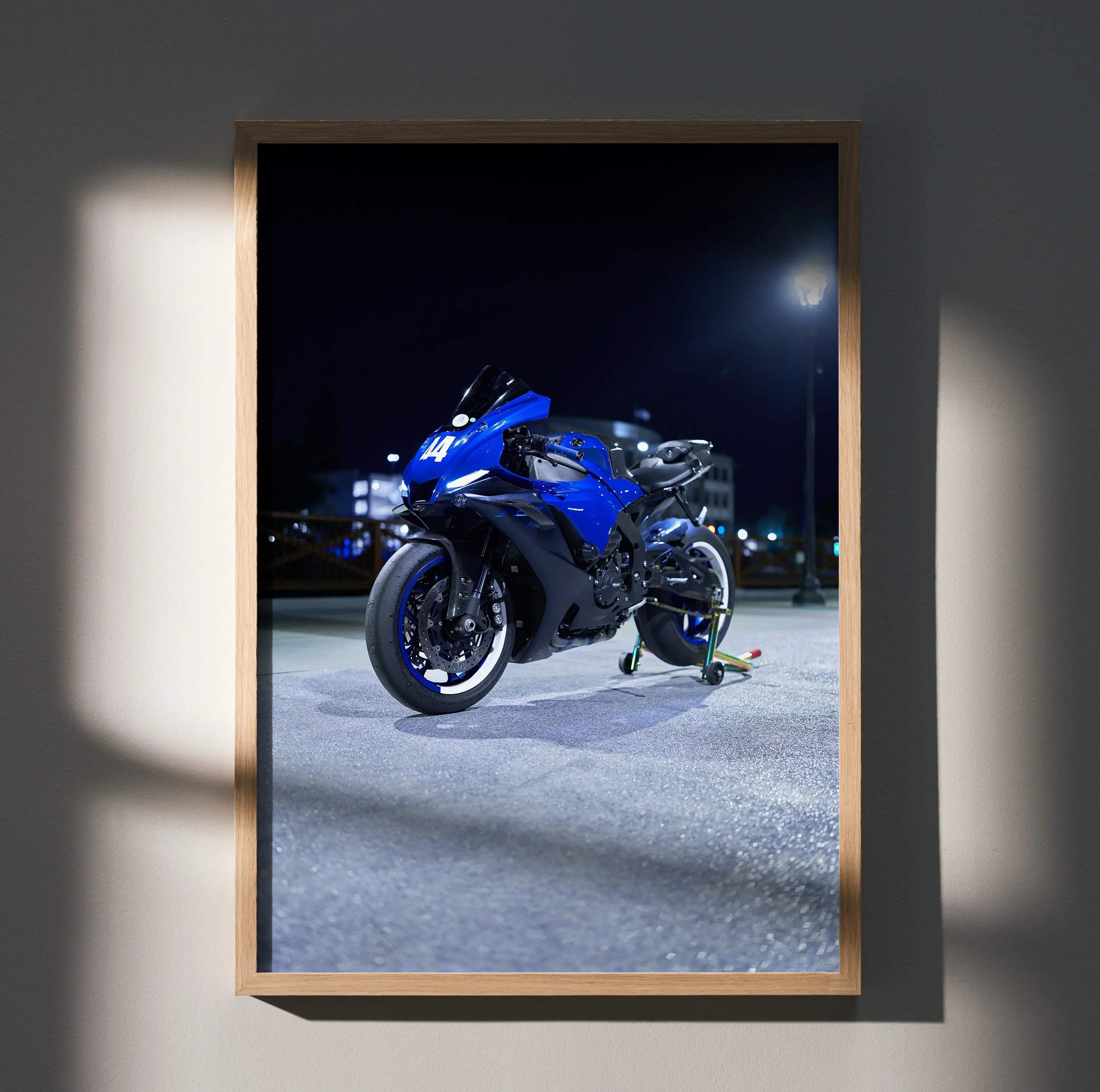 A vibrant blue and black Yamaha R1 motorcycle art print showcasing sleek aerodynamic design in a nighttime urban setting