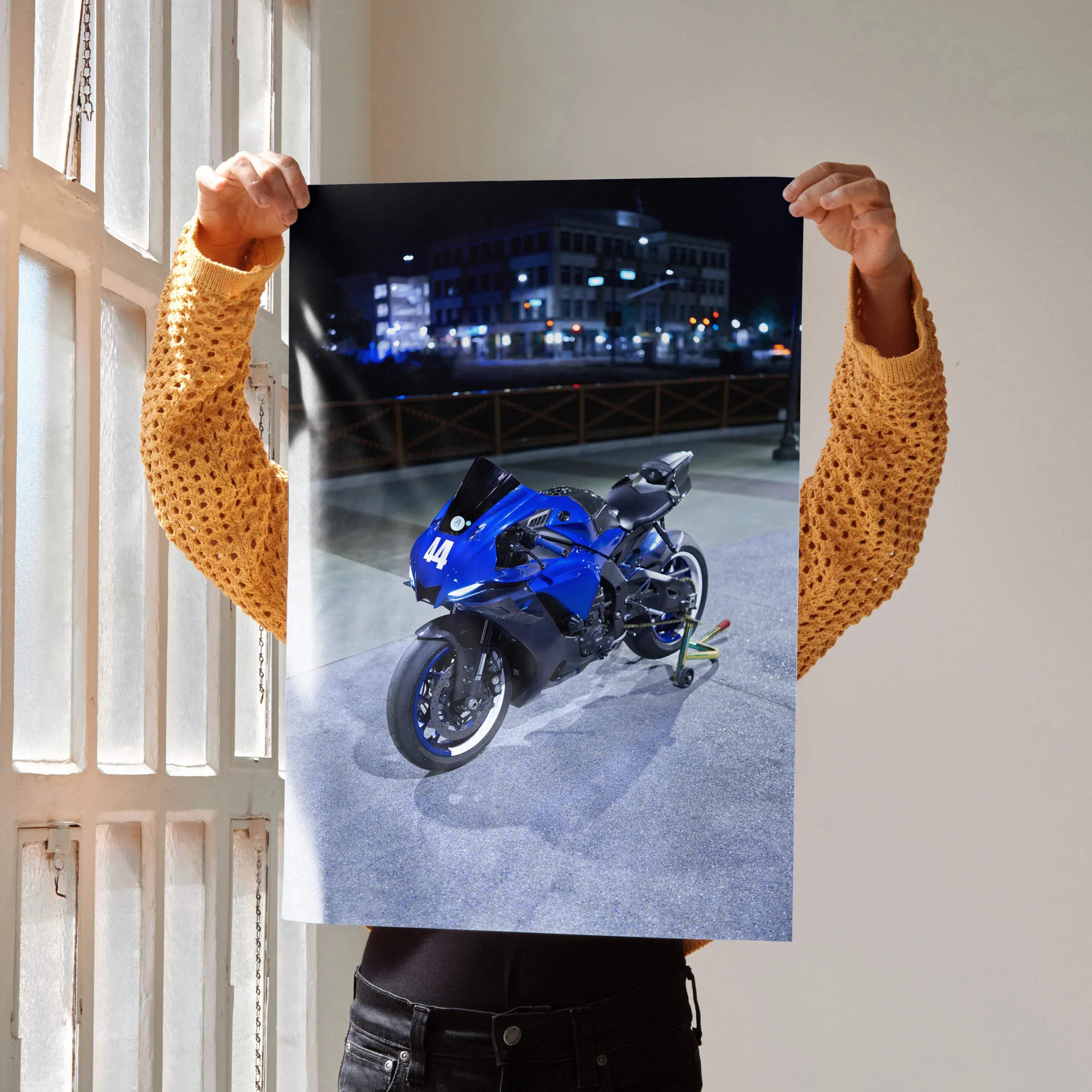 A vibrant blue yamaha r1 motorcycle with black accents and number 44 displayed in a nighttime urban setting poster