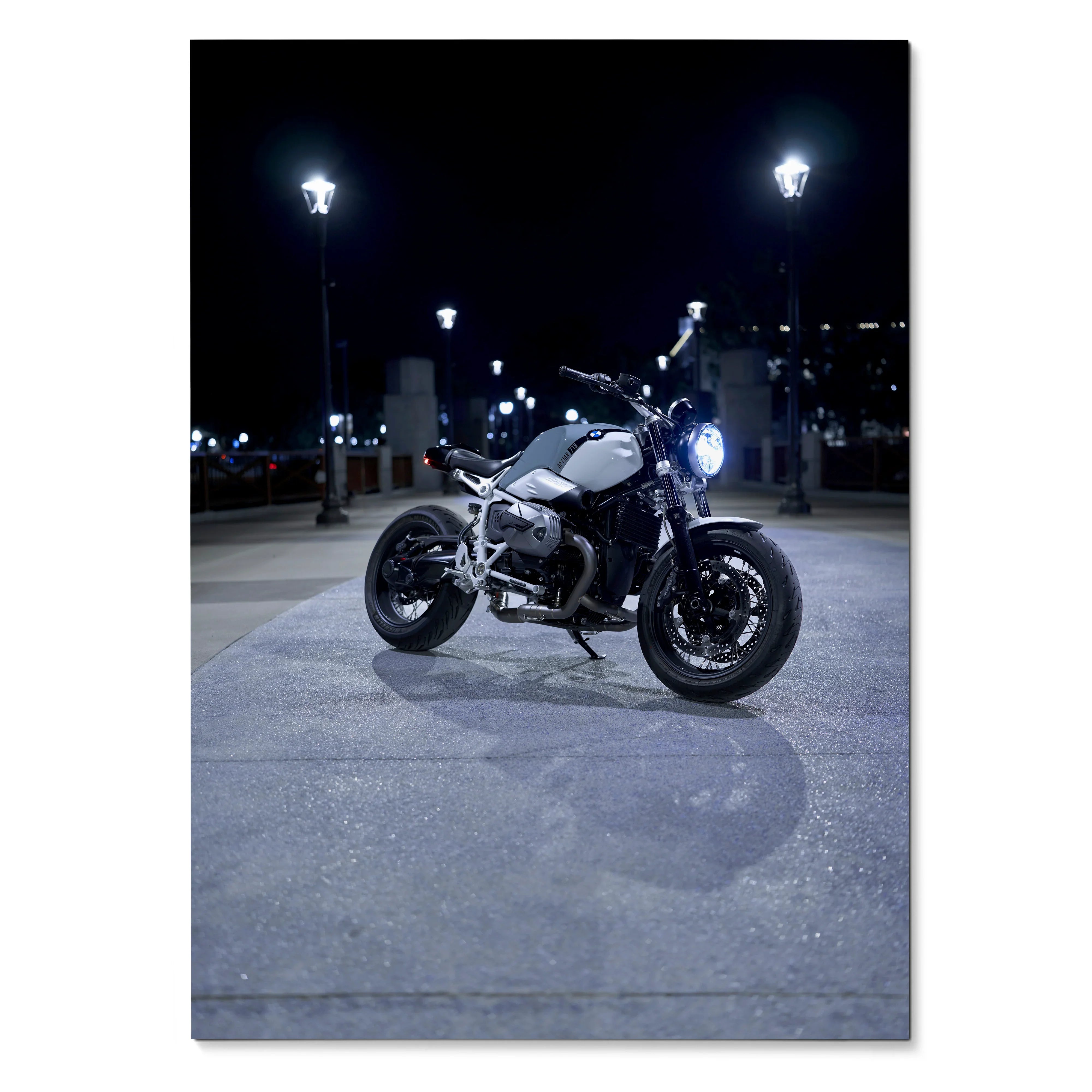 BMW R Nine T motorcycle illuminated at night on street, sleek poster wall art in dark tones.