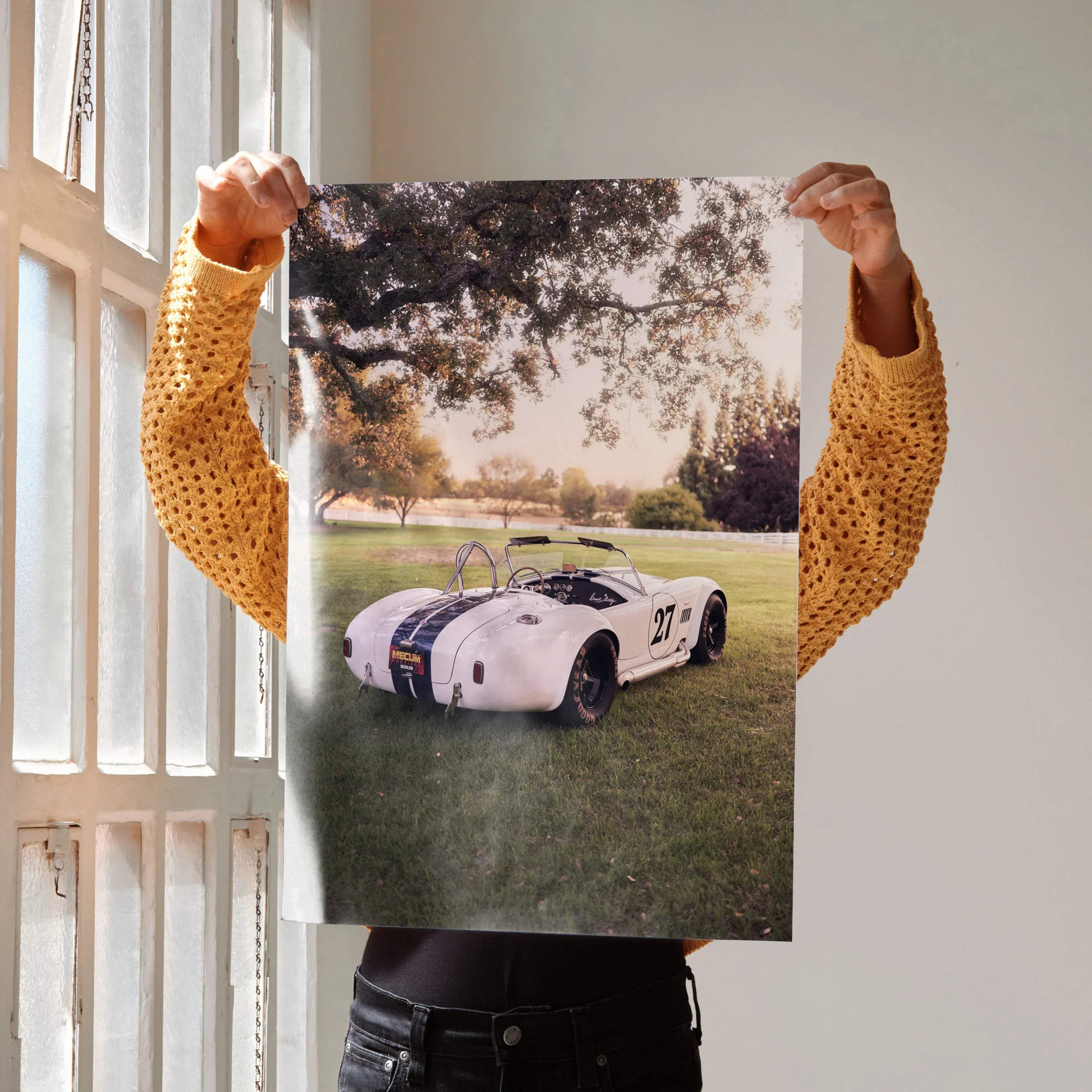 Shelby cobra art poster featuring a white classic race car with black racing stripes and number 27 for enthusiasts