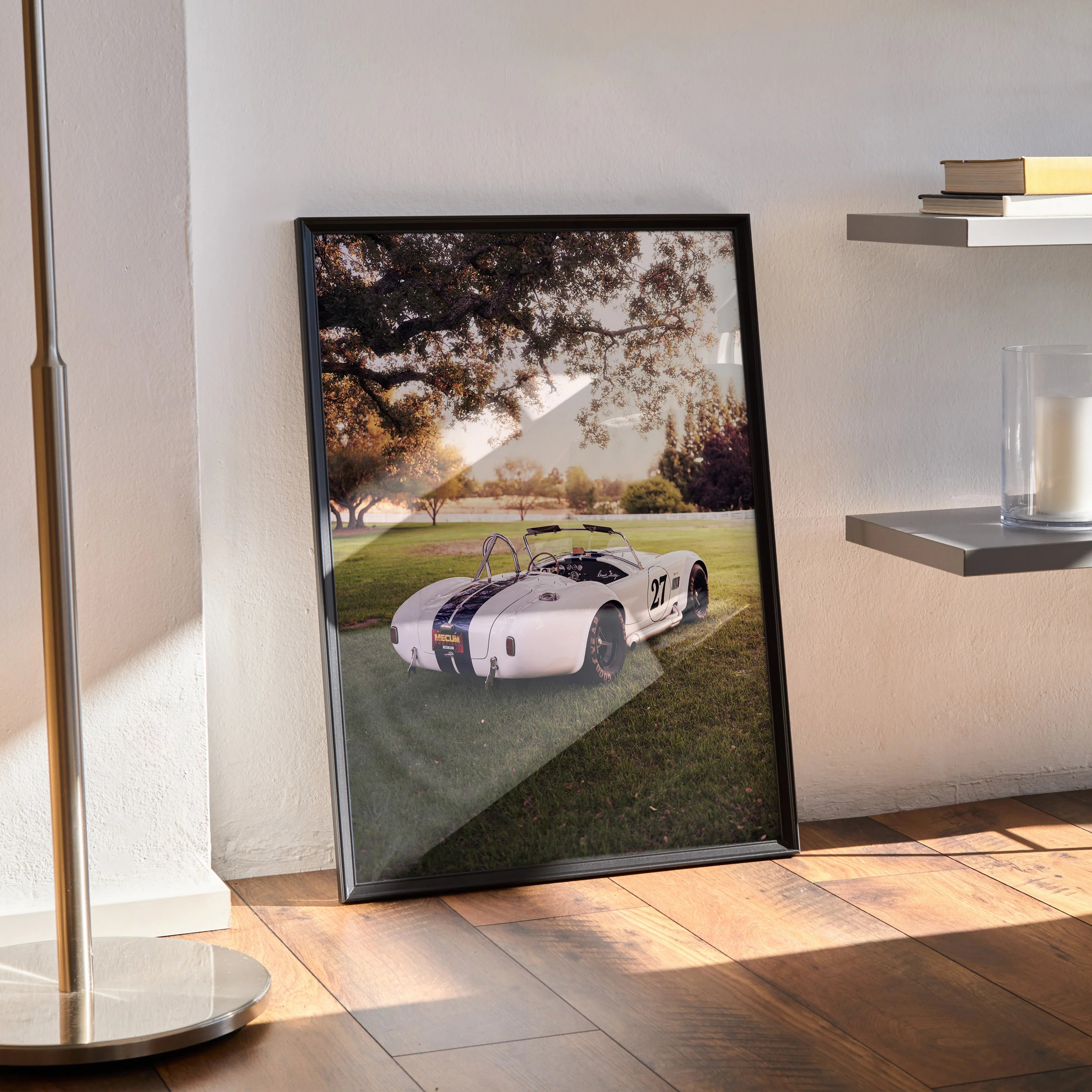 Shelby Cobra vintage car poster with racing stripes leaning against wall as stylish wall art.