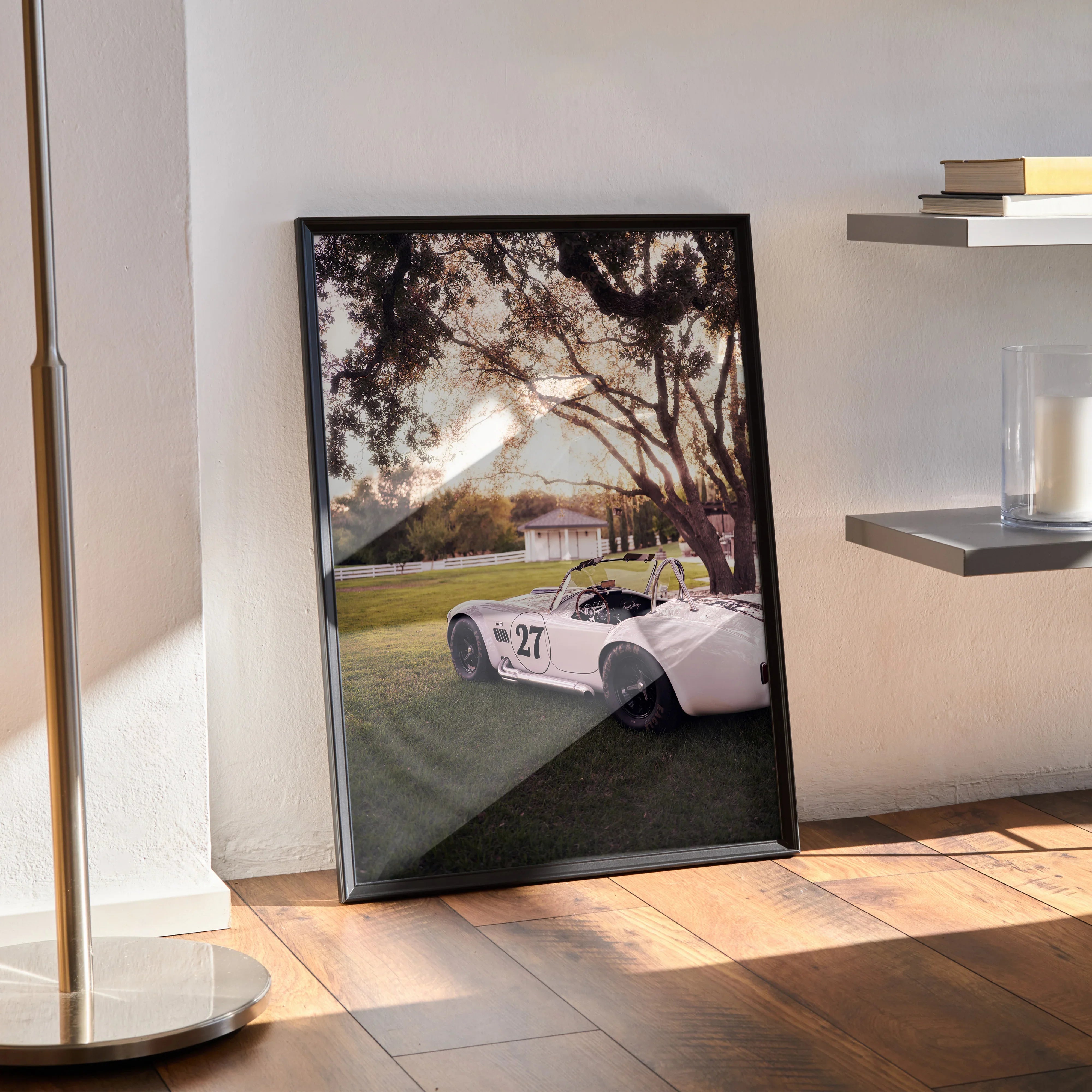 Shelby Cobra #002 poster wall art showing white classic car under sunset with trees and grassy field.