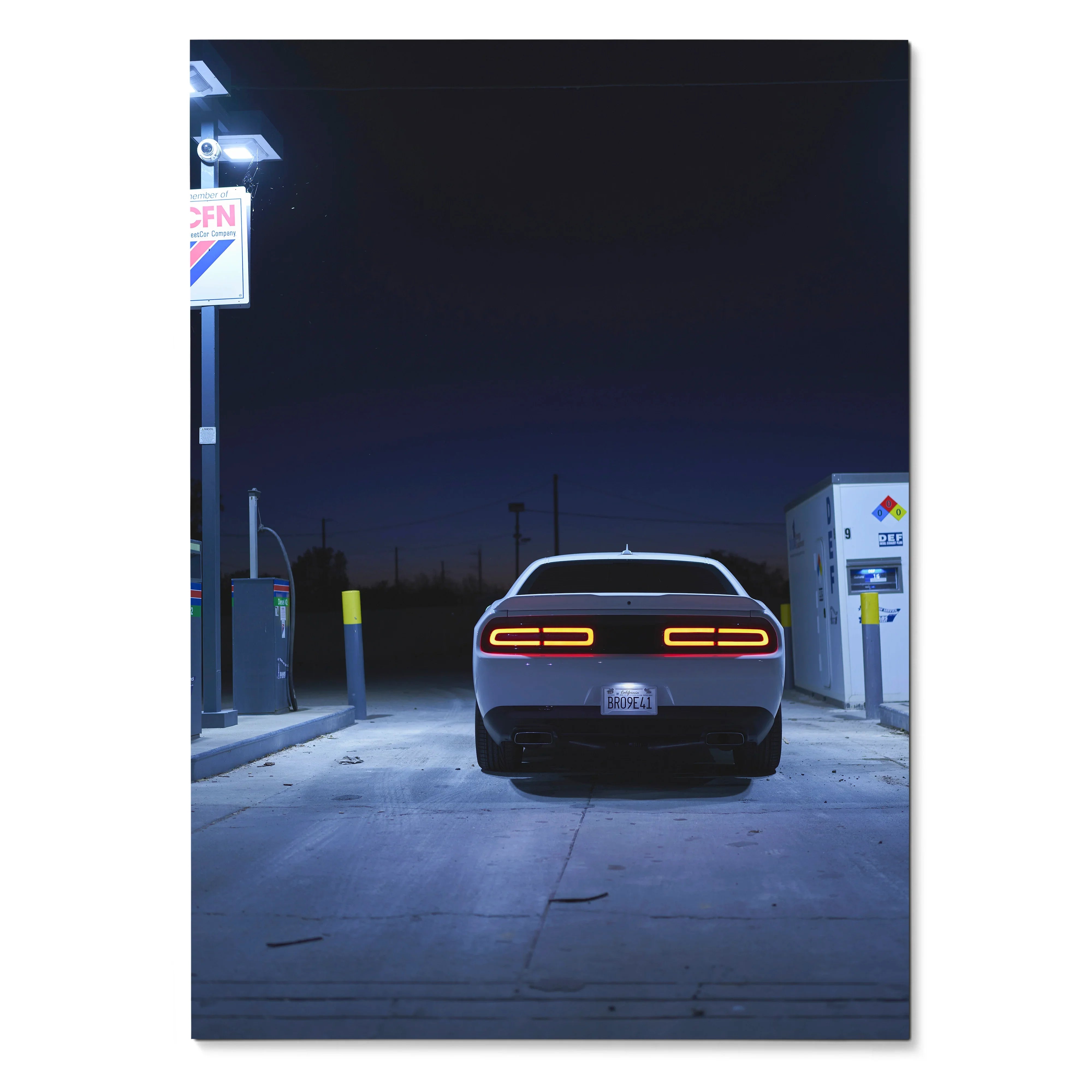 Dodge Challenger rear view at night in gas station illuminated poster wall art.