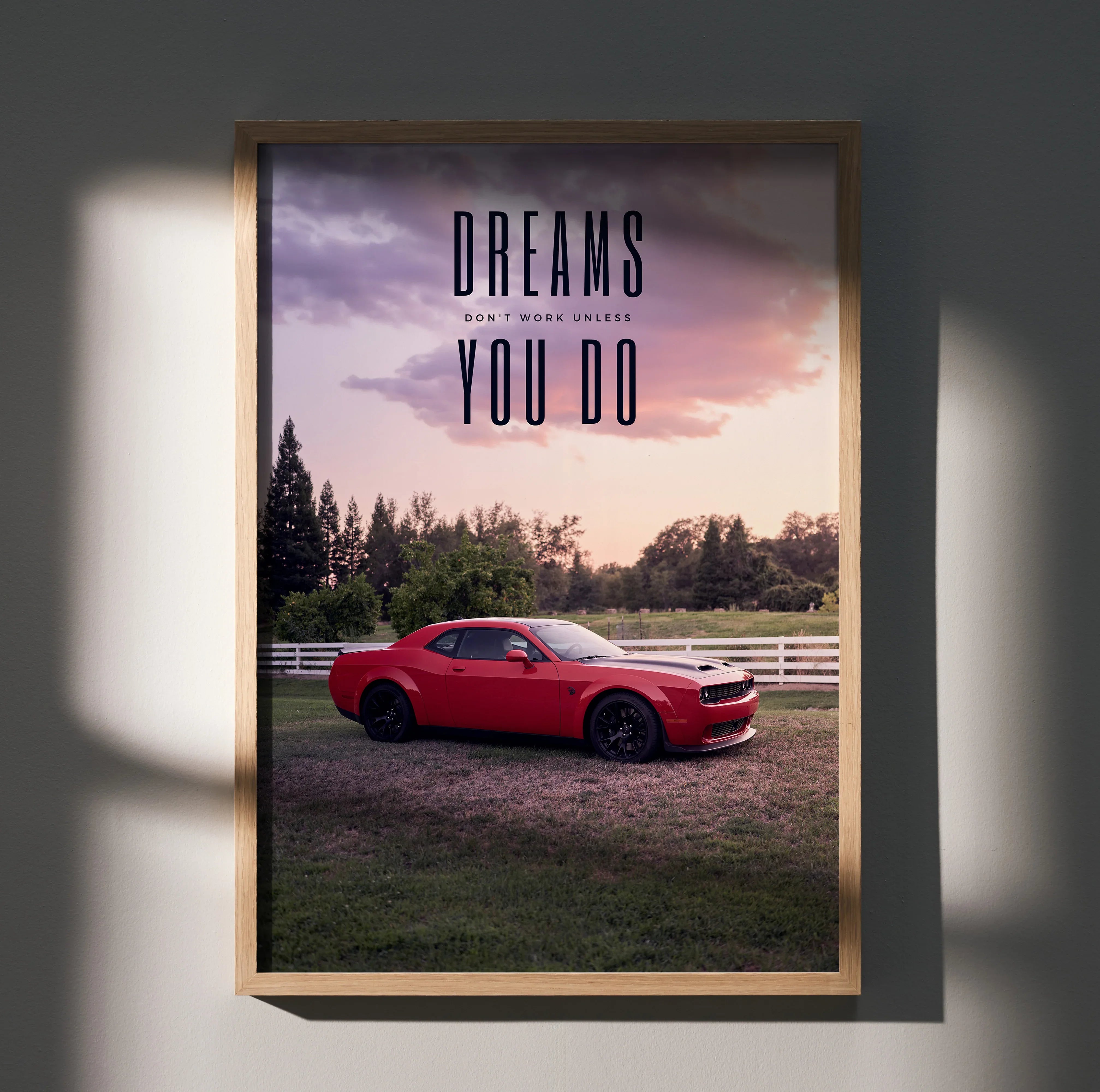 Motivational poster wall art featuring red Dodge Challenger Hellcat with inspiring text against sunset sky.