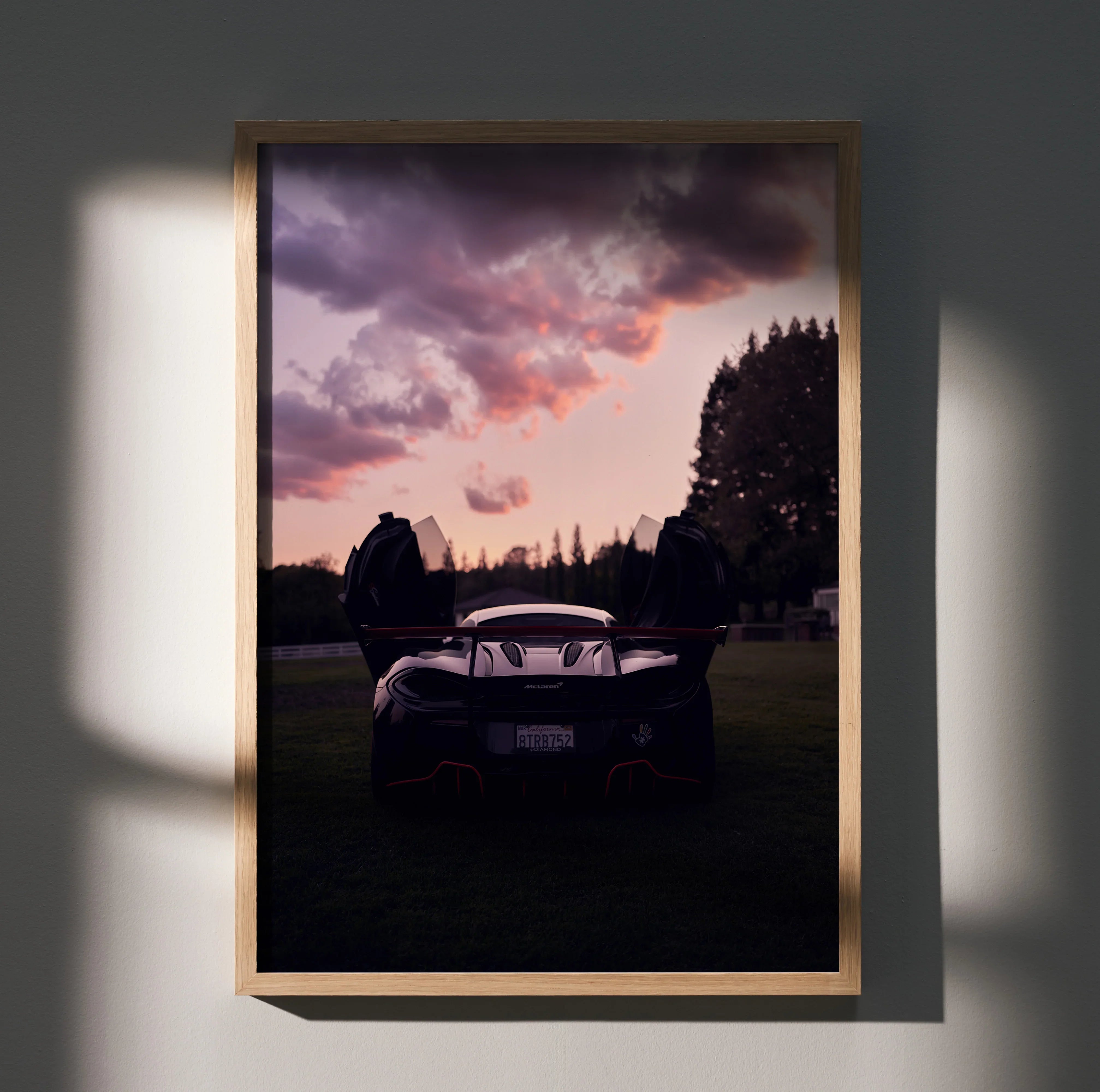 McLaren 570s luxury car poster with dramatic sunset sky and dark forest background wall art.