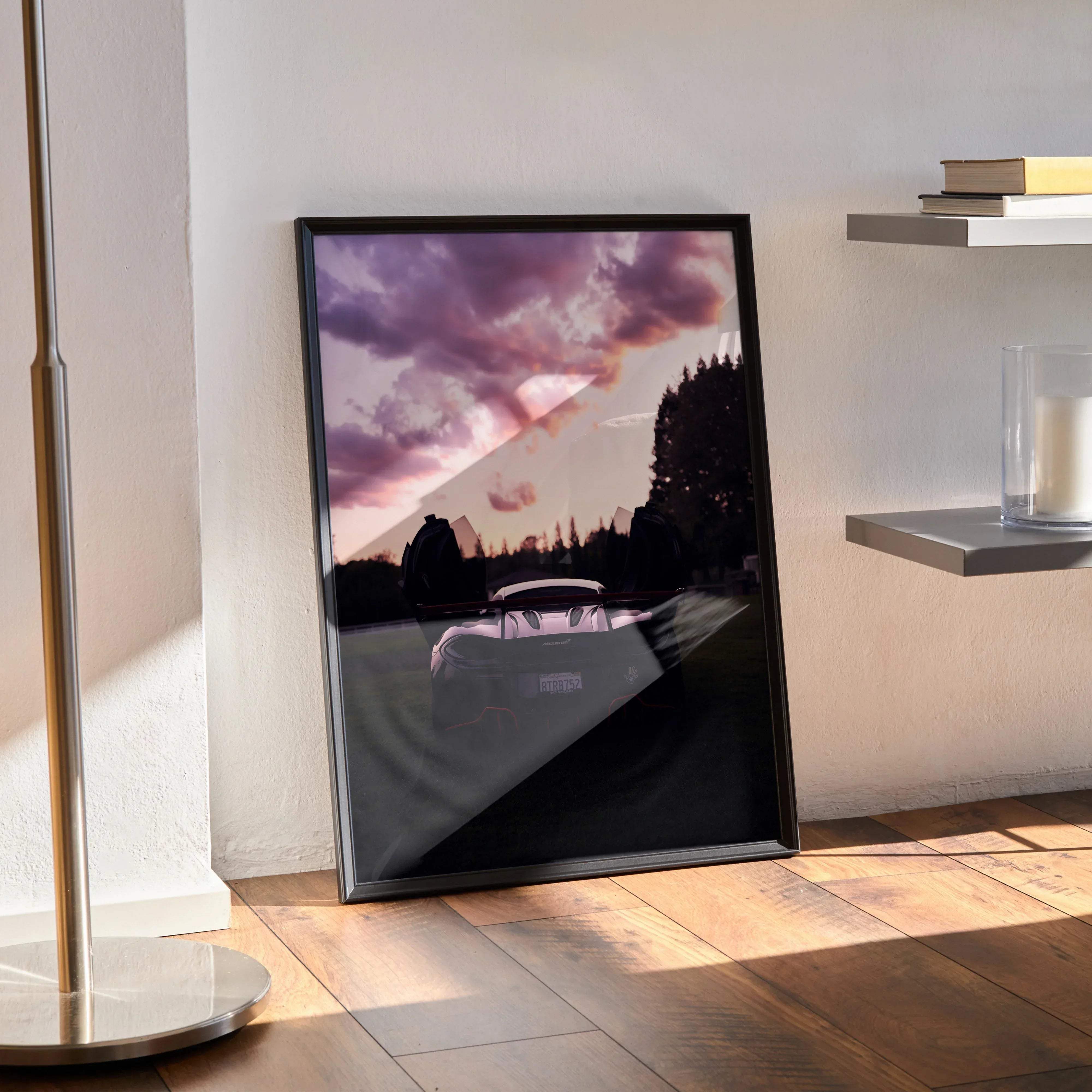 Black-framed art print of a mclaren 570s luxury car under a dramatic purple and pink sky for home decor