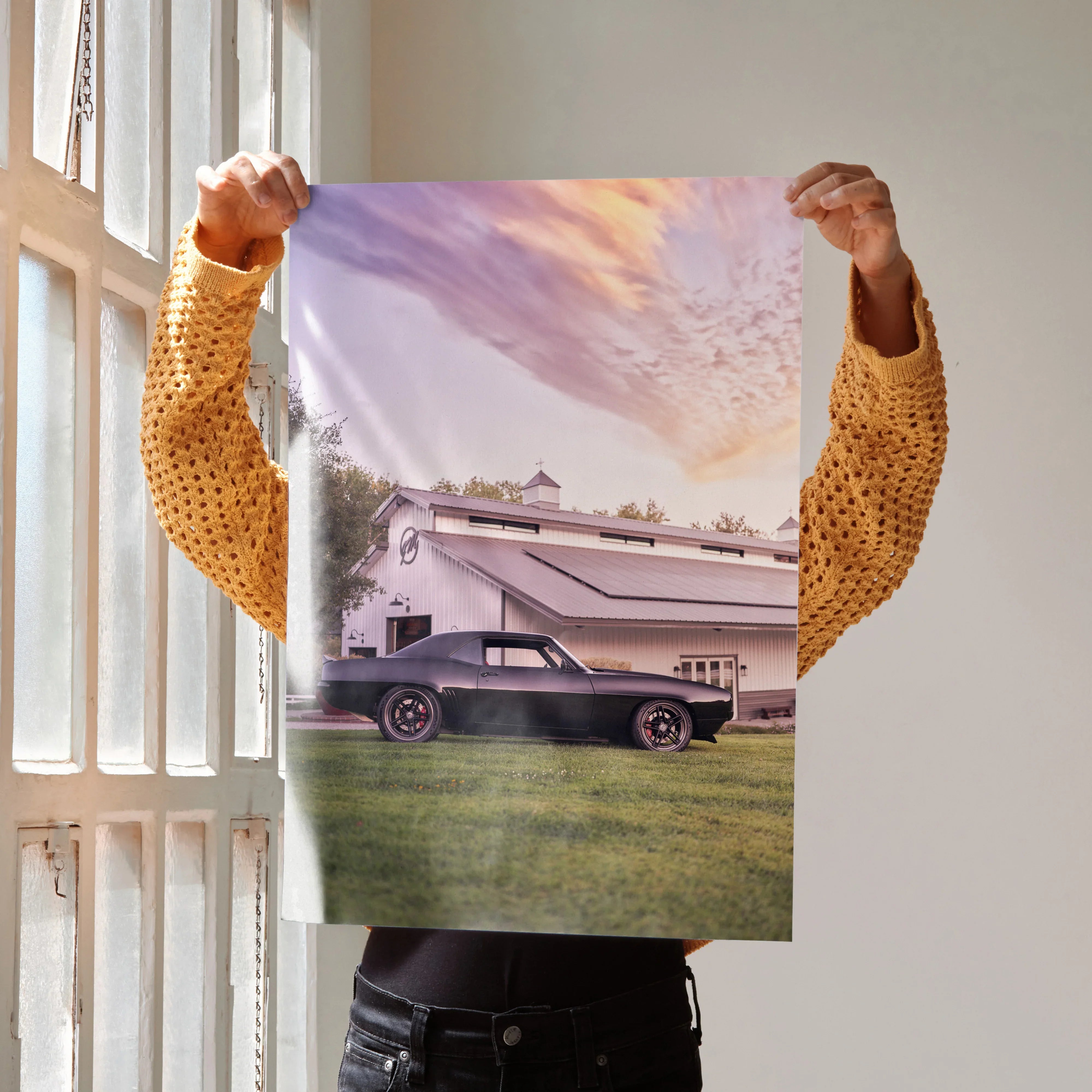 Poster of a black 1969 Camaro parked in front of a retro trailer at sunset, wall art.