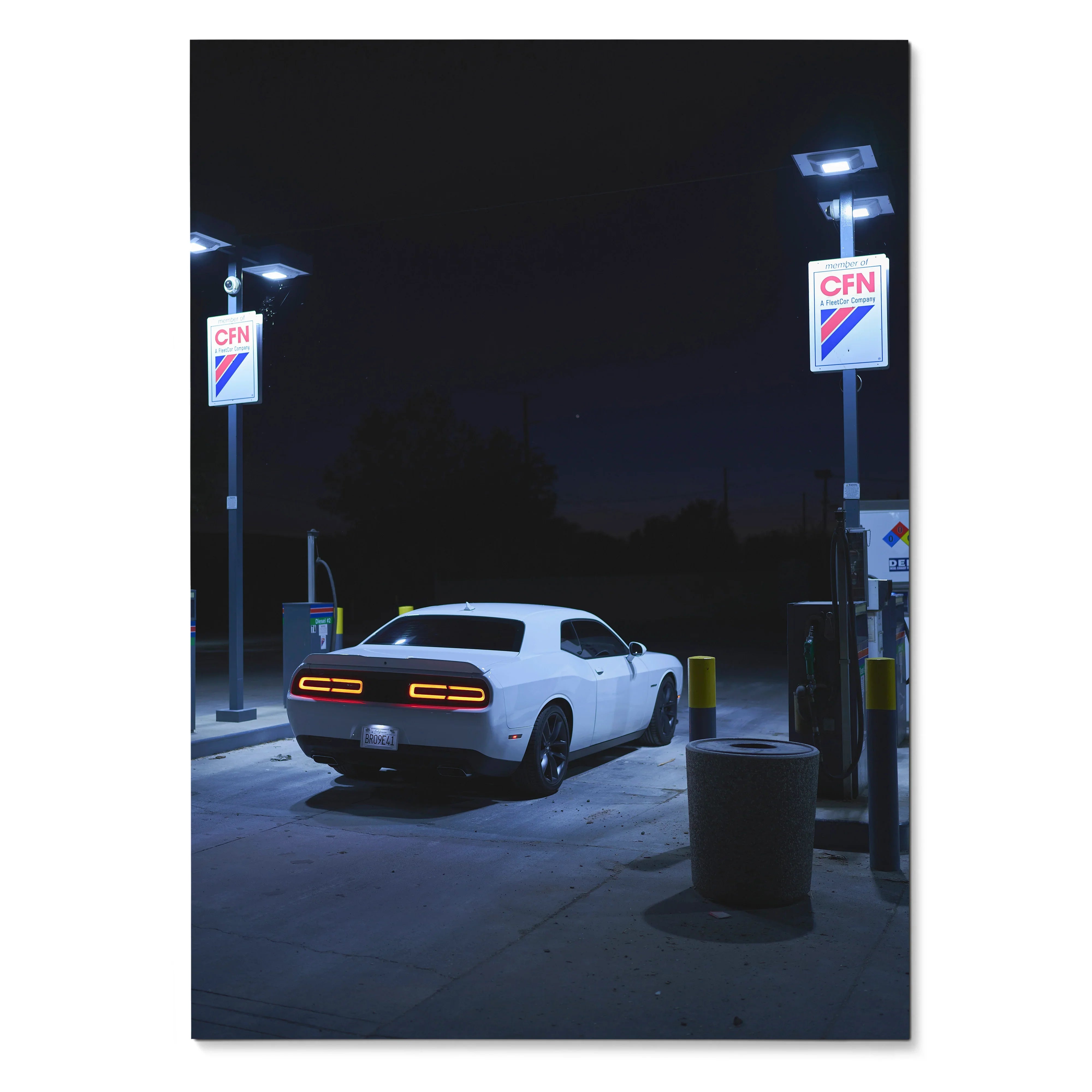 Dodge Challenger parked at gas station night scene poster wall art with deep shadows and glowing lights.