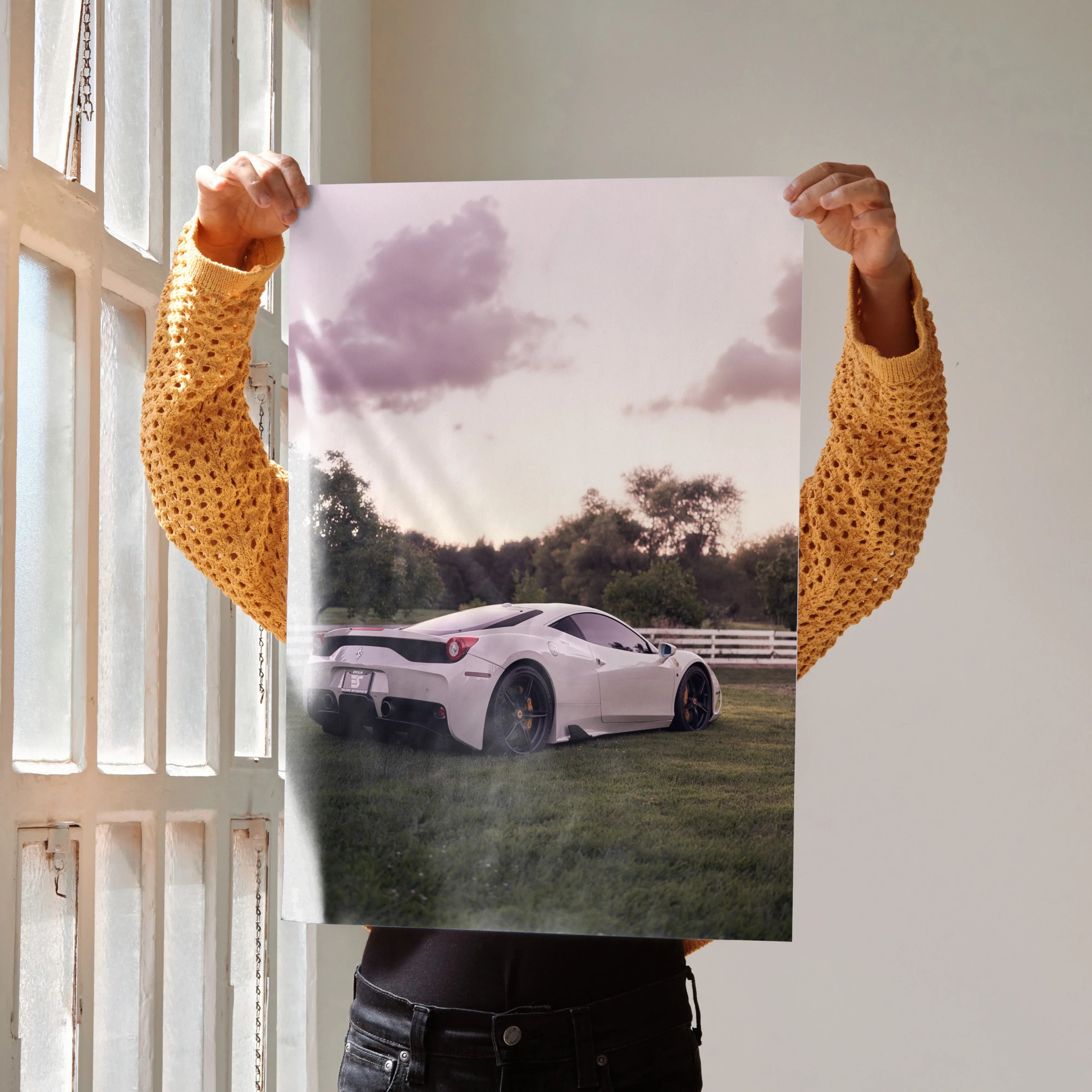 Poster wall art featuring a white Ferrari 458 Italia parked on grass under a cloudy sky at sunset.