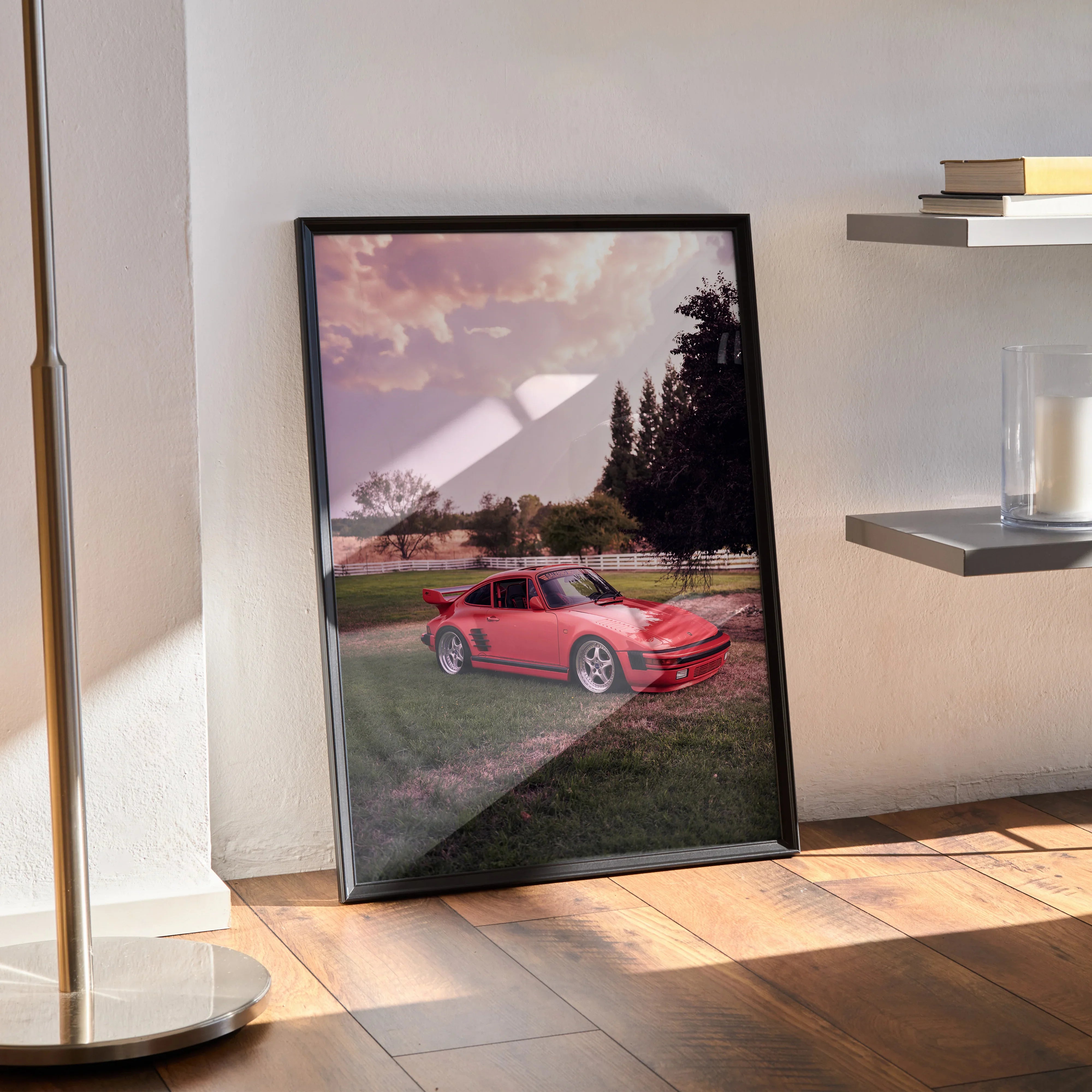 Porsche 911 Turbo Slant-Nose poster with red car and sunset sky, framed wall art leaning on floor.