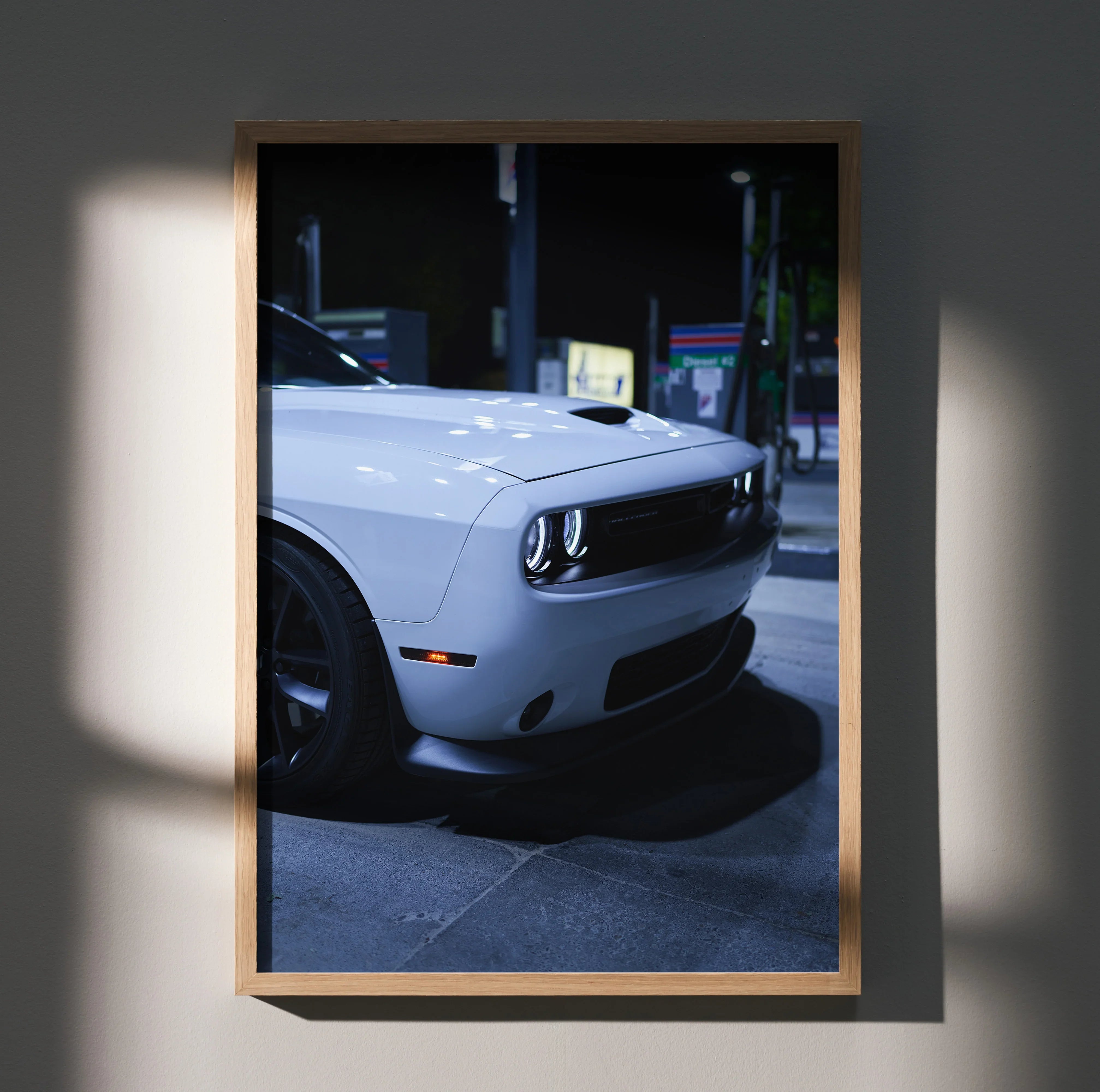 Dodge Challenger close-up in dim light wall art poster with black frame.