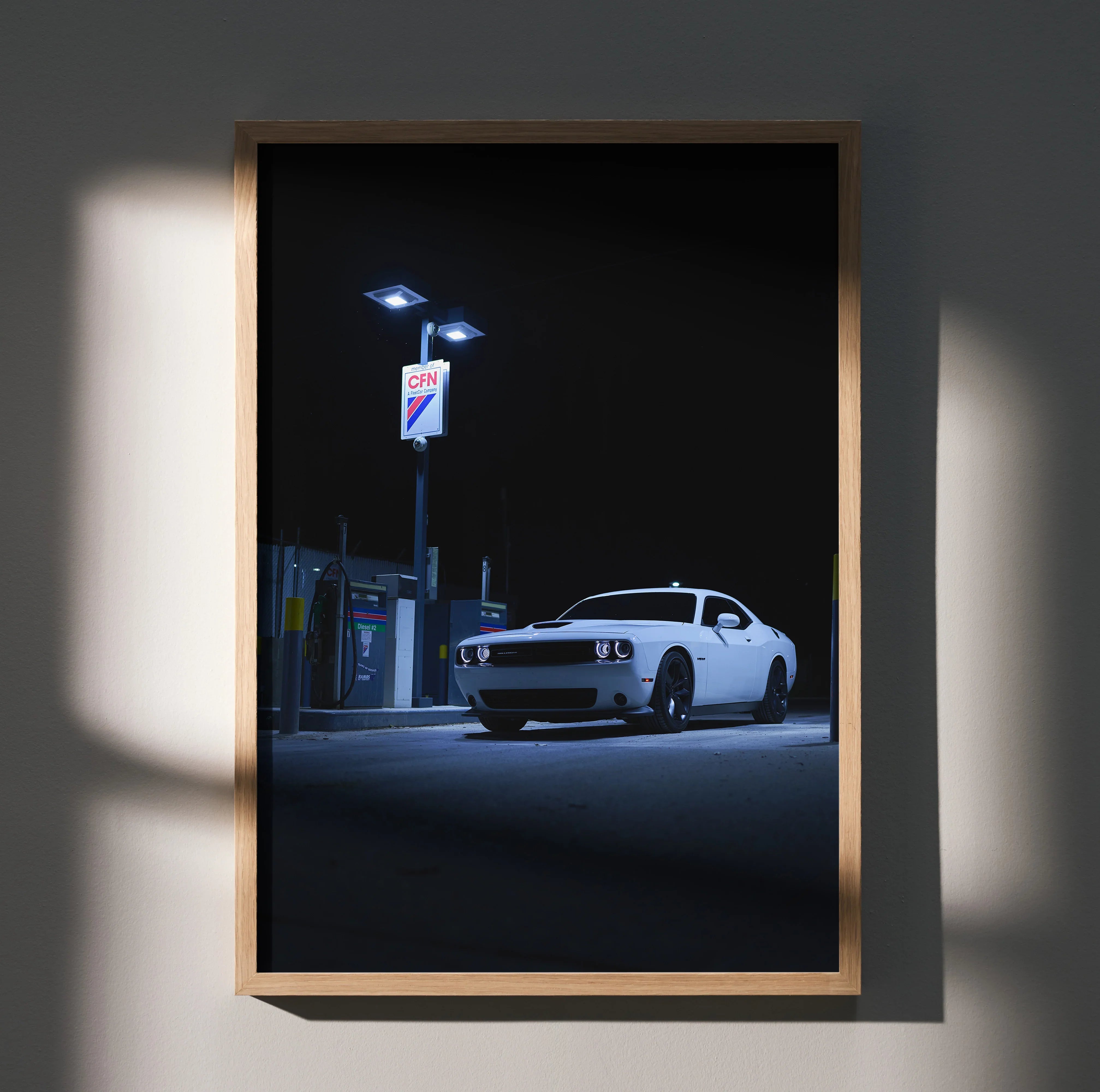 Dodge Challenger poster showing white muscle car under gas station lights at night wall art.