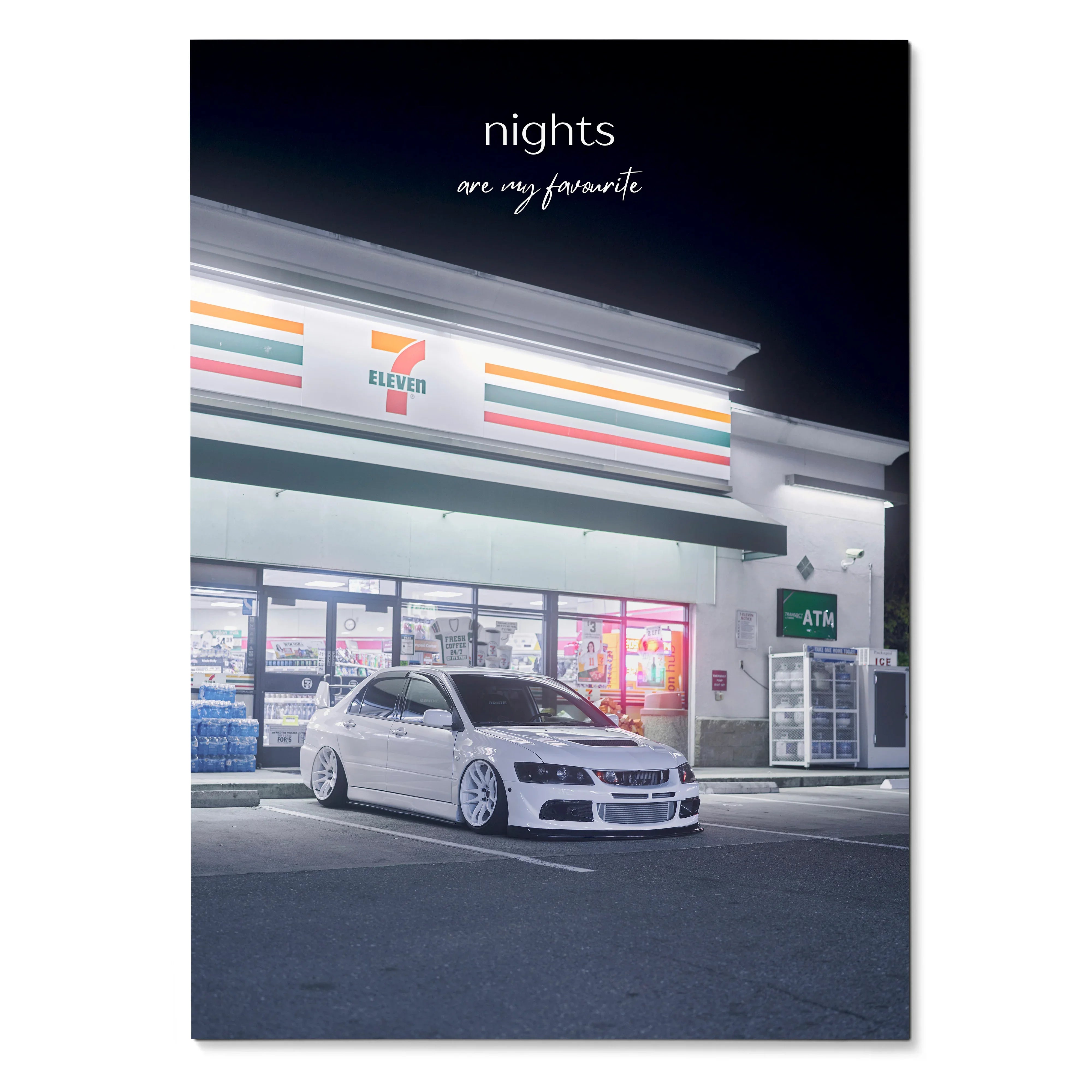 Motivational poster wall art featuring a white Mitsubishi Evo 8 parked at night in front of a brightly lit store with.