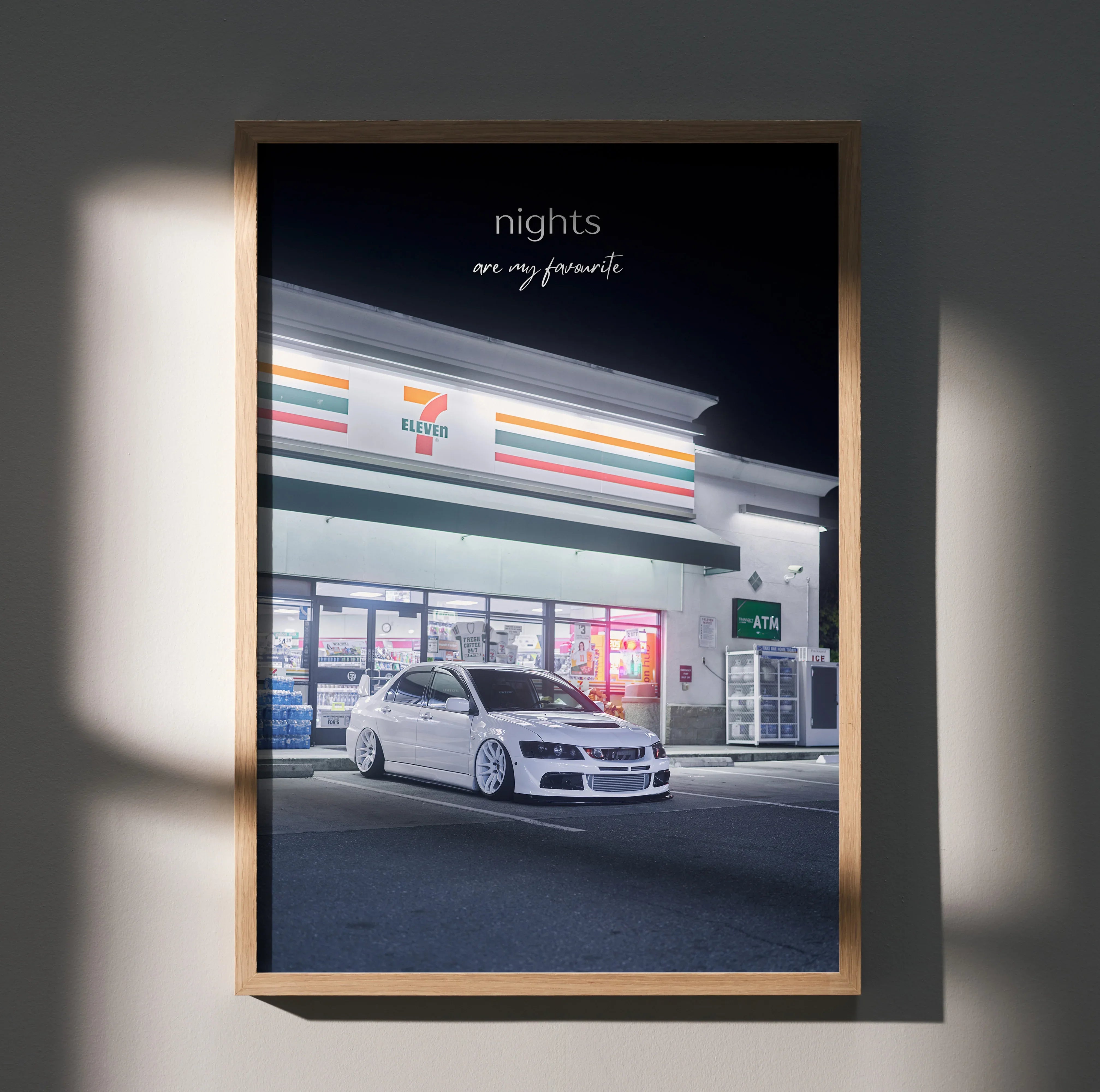 Mitsubishi Evo 8 parked outside store at night motivational poster wall art in wooden frame.
