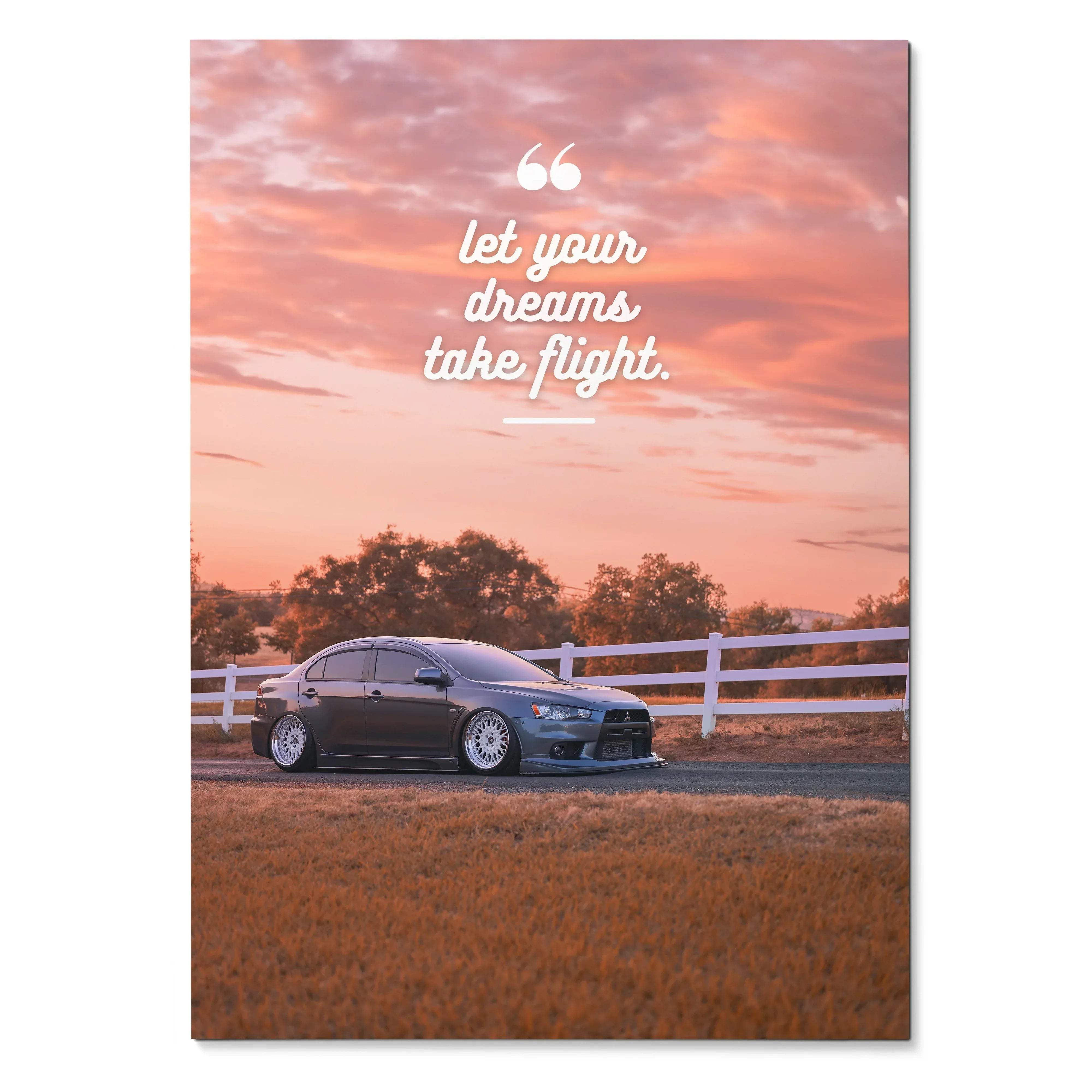 Motivational poster wall art with Mitsubishi Evo 10 under a pink sunset sky and inspiring white text.