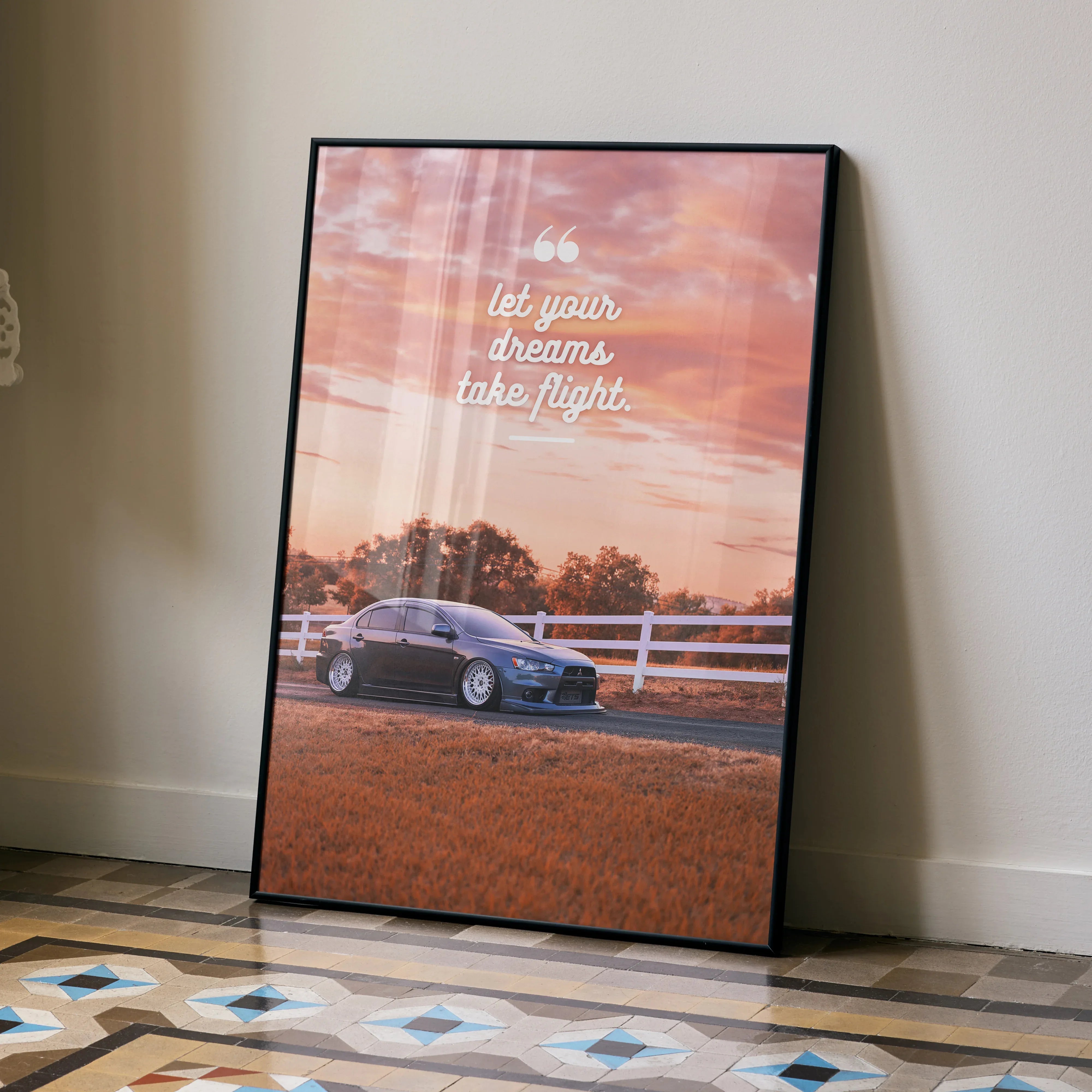 Motivational poster wall art featuring a Mitsubishi Evo 10 with inspiring text against a sunset sky.