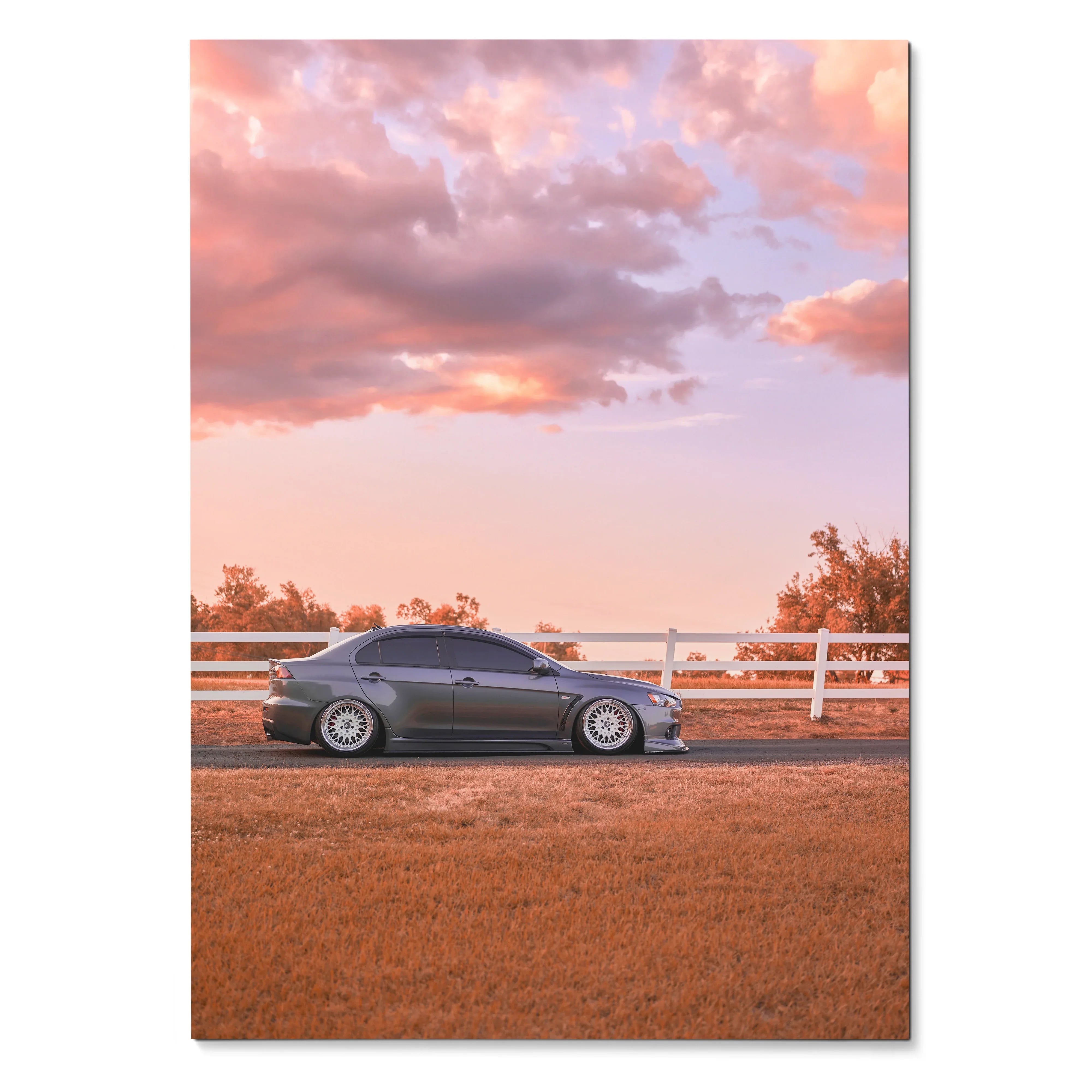 Mitsubishi Evo 10 parked on dirt road at sunset with pink sky poster wall art.
