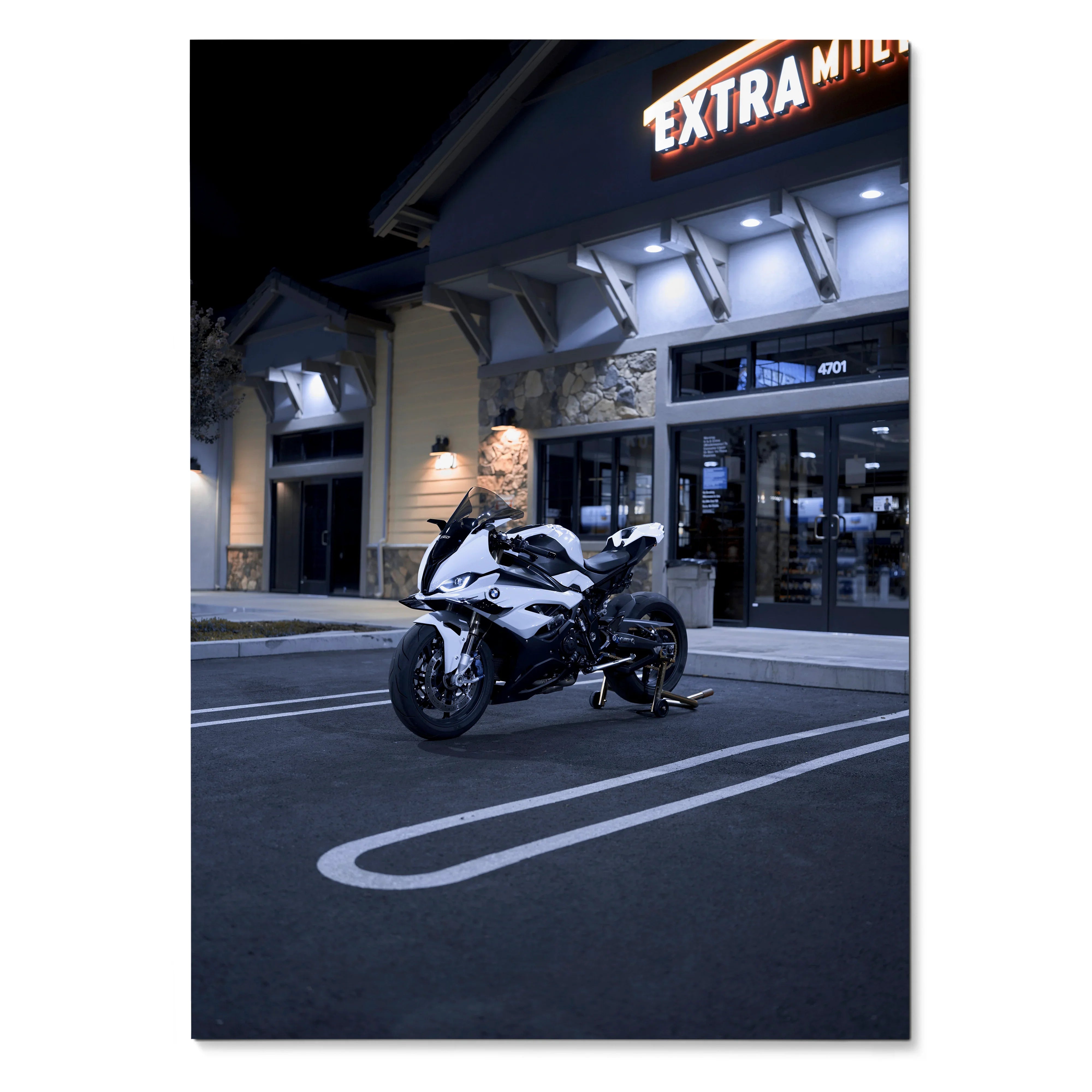 BMW S1000RR motorcycle parked at night outside a lit Extra Mile store poster wall art.