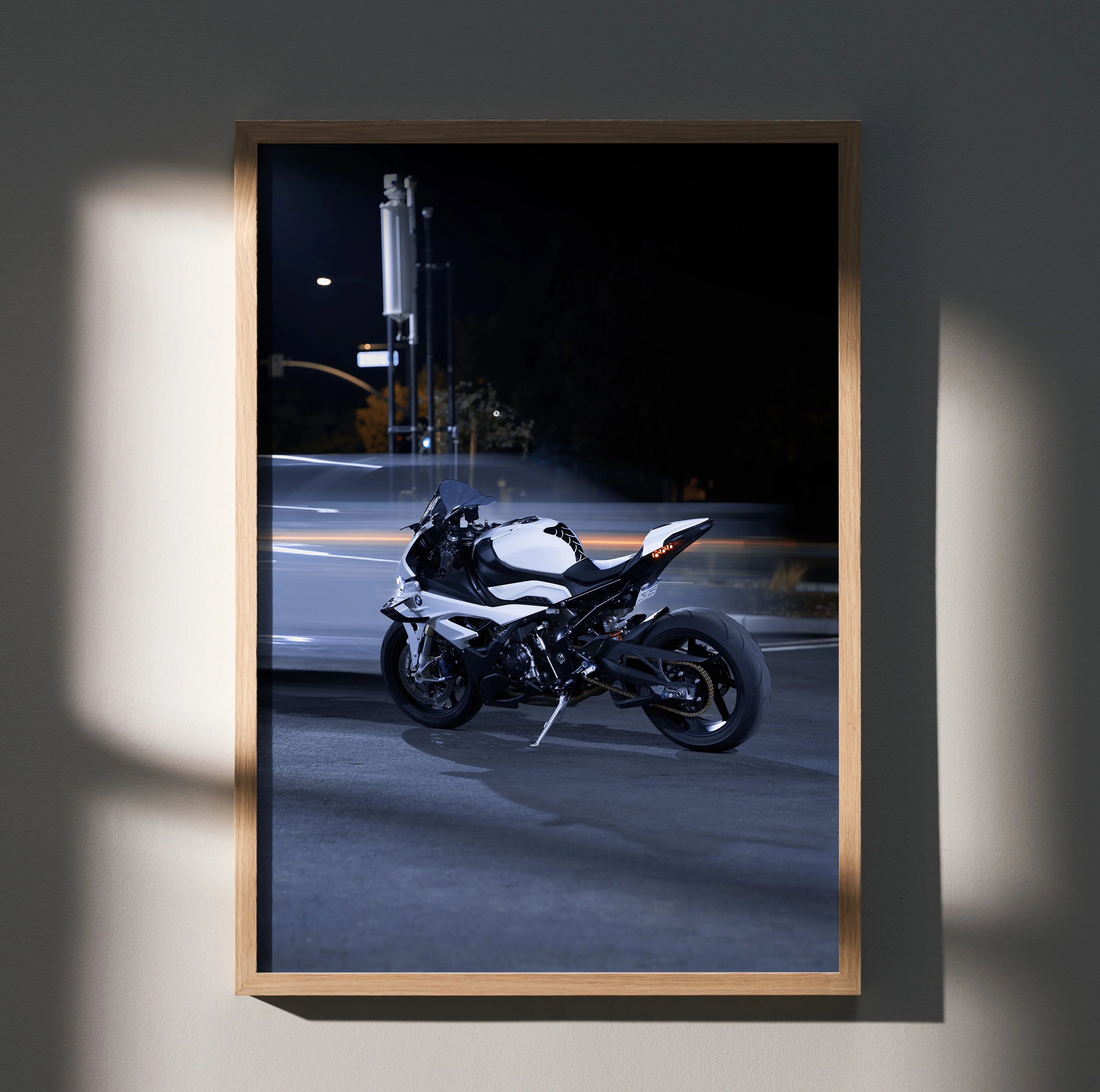 BMW S1000RR motorcycle poster wall art with sleek white and black bike against dark city background.