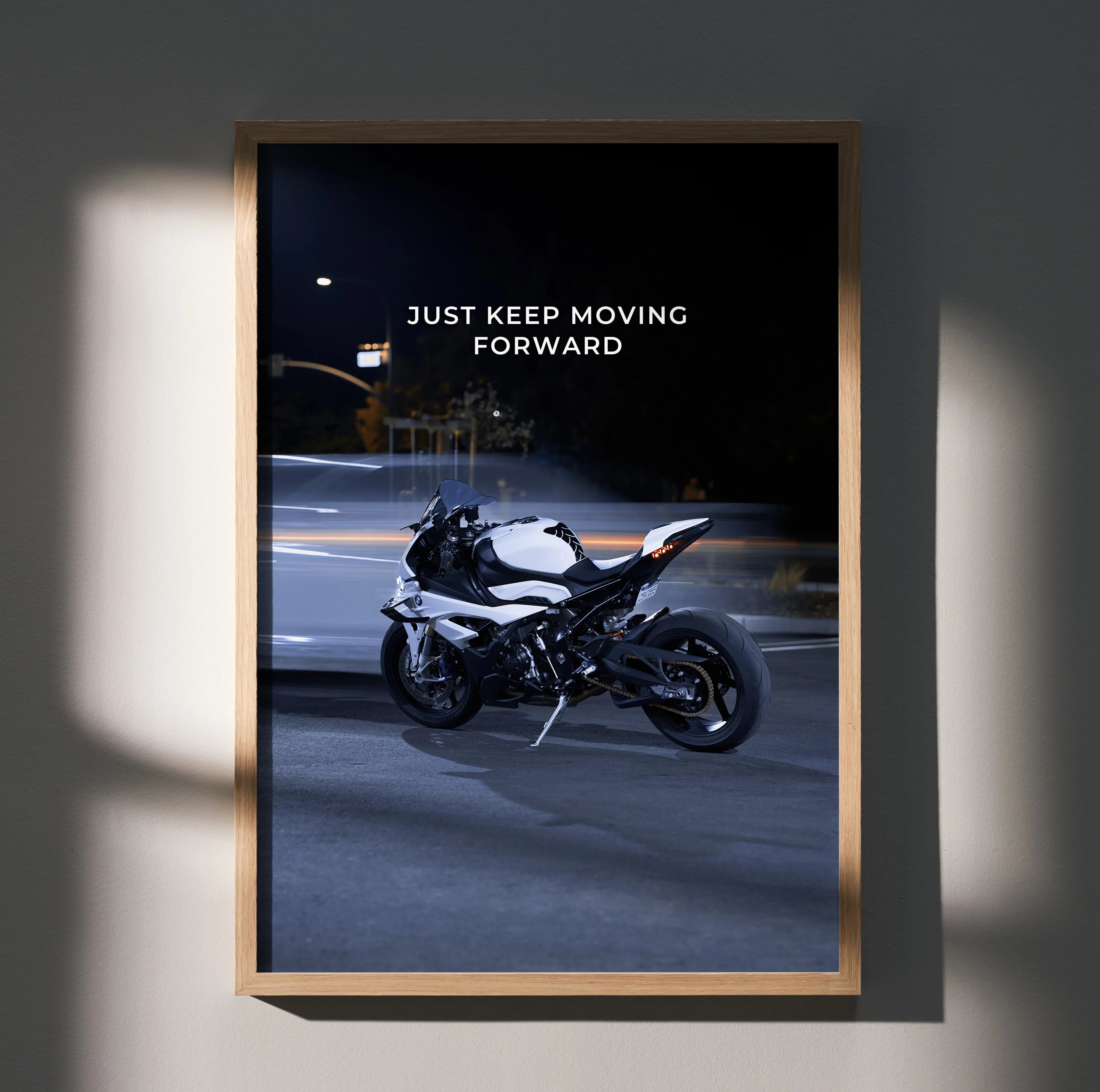 BMW S1000RR motorcycle with "Just Keep Moving Forward" motivational text poster wall art in wooden frame.