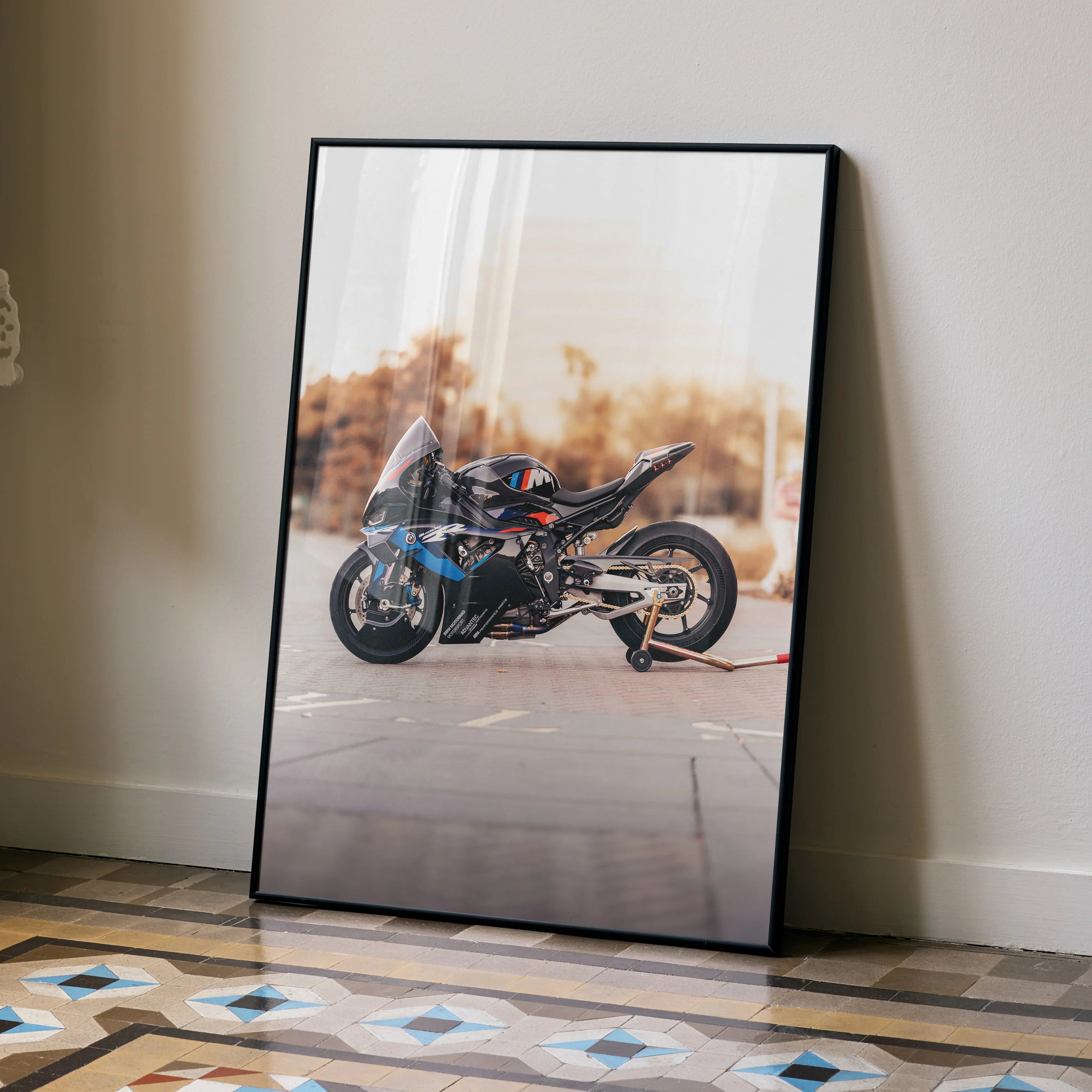 BMW M1000RR motorcycle poster leaning against wall with modern floor tiles, wall art decor.