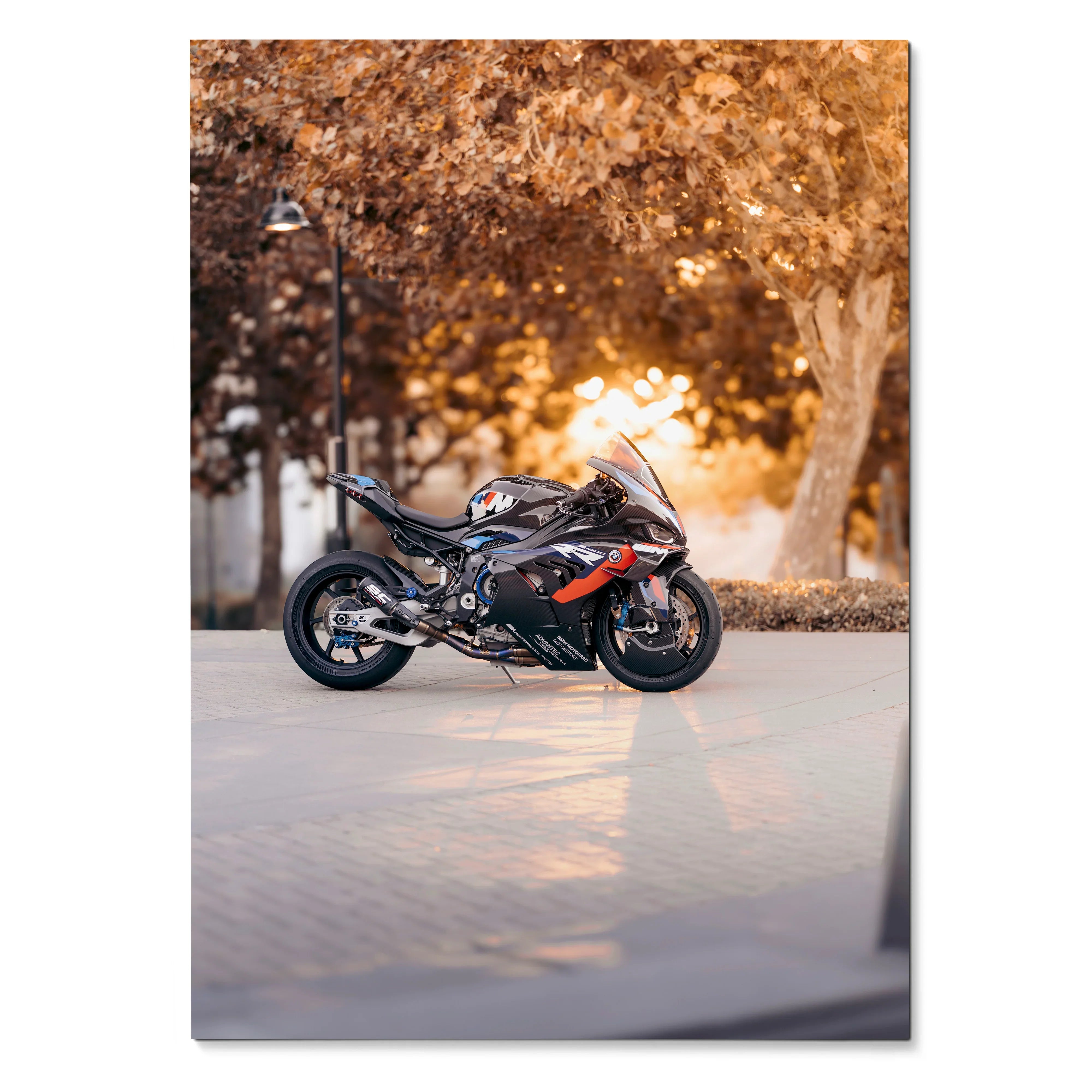 BMW M1000RR motorcycle parked on sunlit street with autumn trees poster wall art.