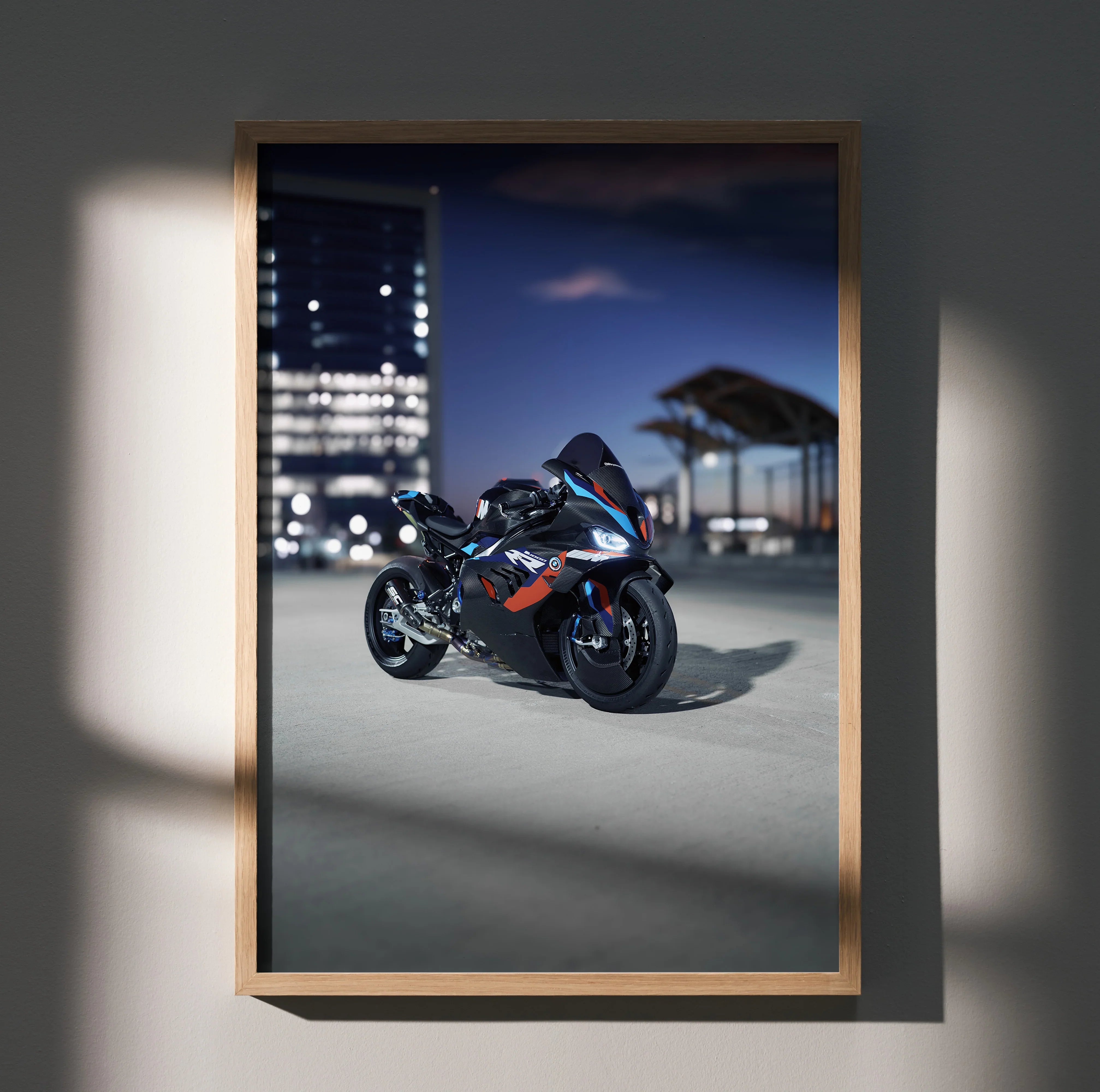 BMW M1000RR motorcycle poster wall art with sleek black and blue sportbike in urban night setting.