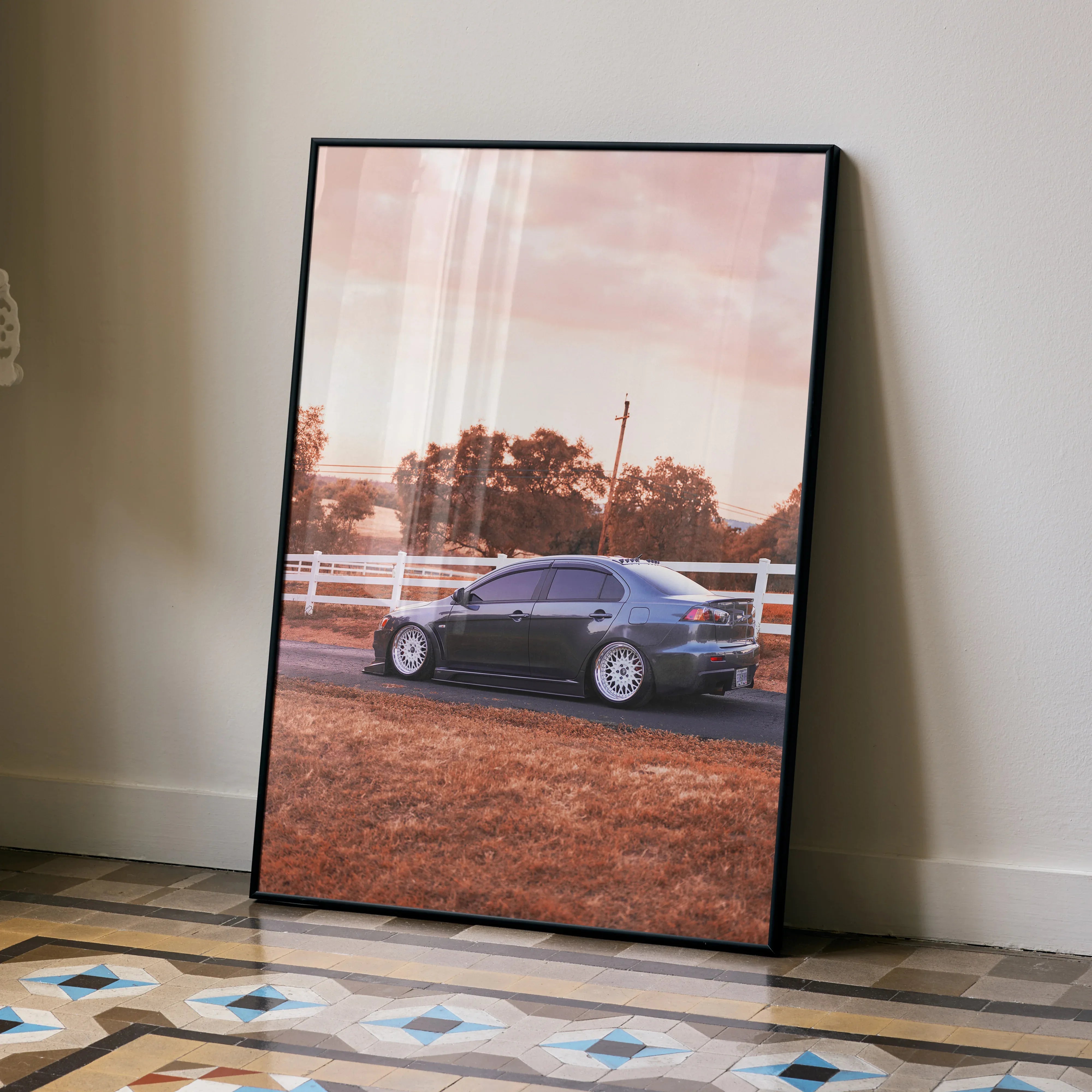 Mitsubishi Evo 10 car poster with sunset background in sleek black frame wall art.