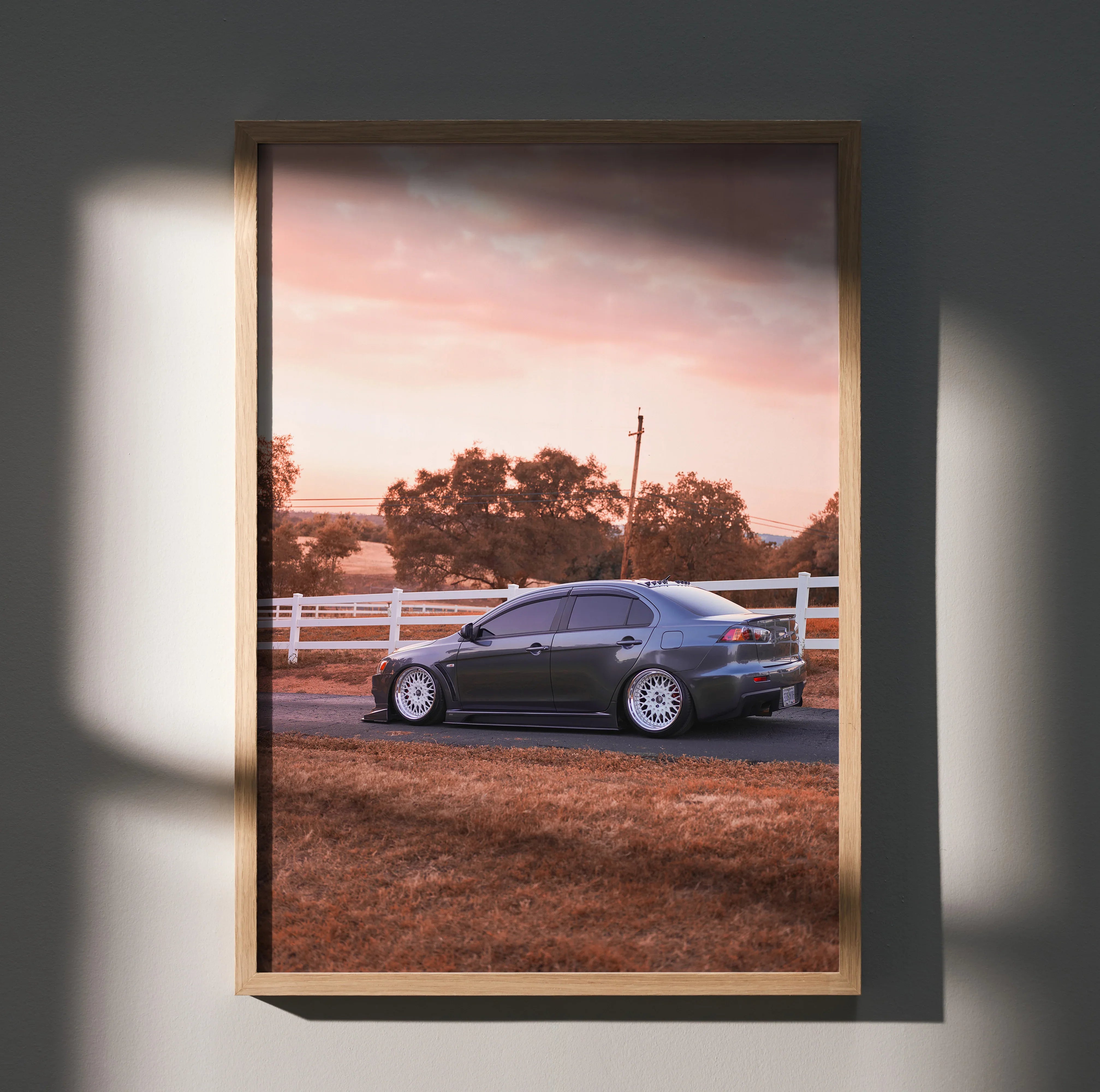 Mitsubishi Evo 10 parked on dirt road at sunset poster wall art in wooden frame.