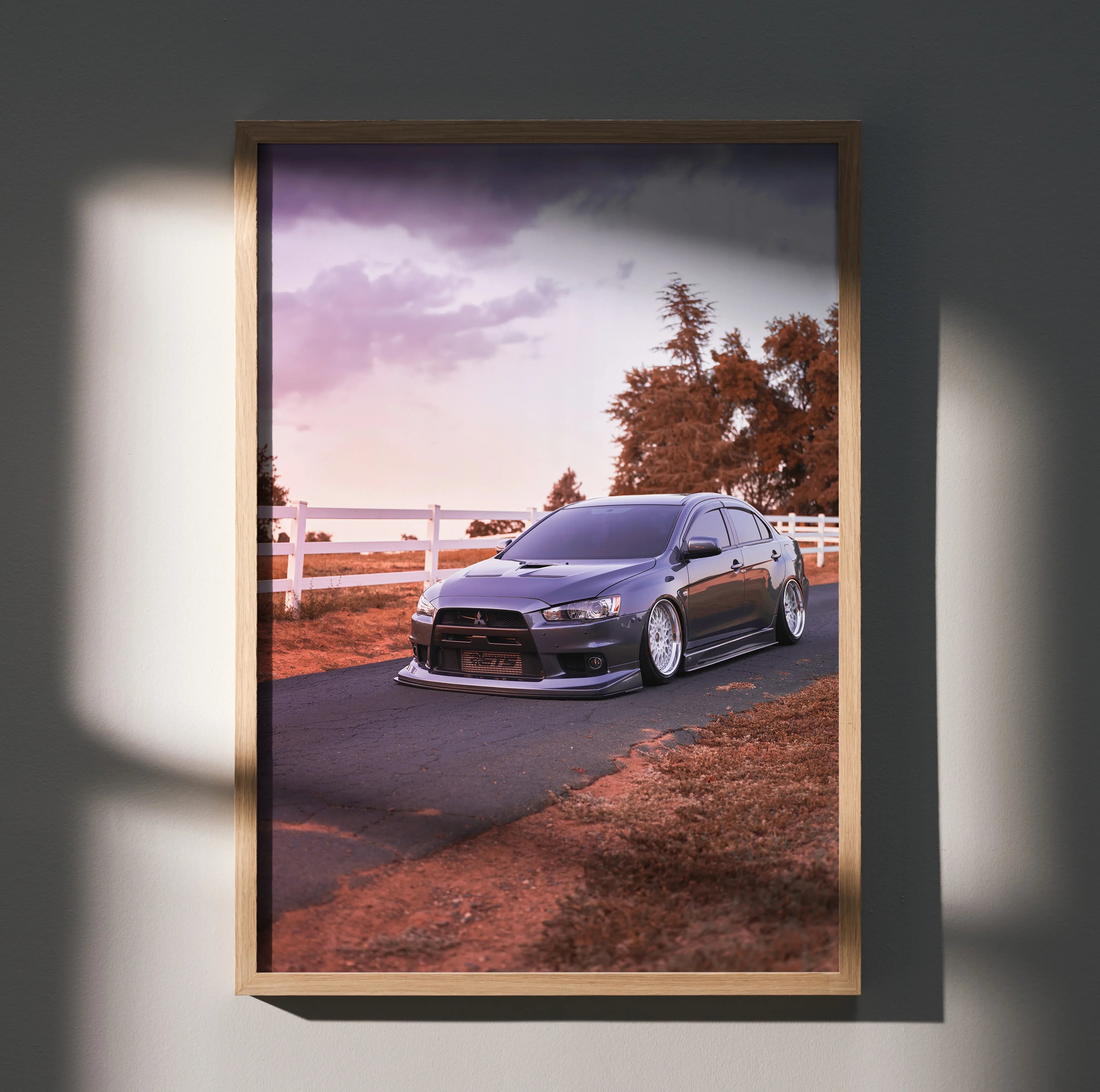 Mitsubishi Evo 10 poster wall art showcasing the car on a road at sunset with warm tones.